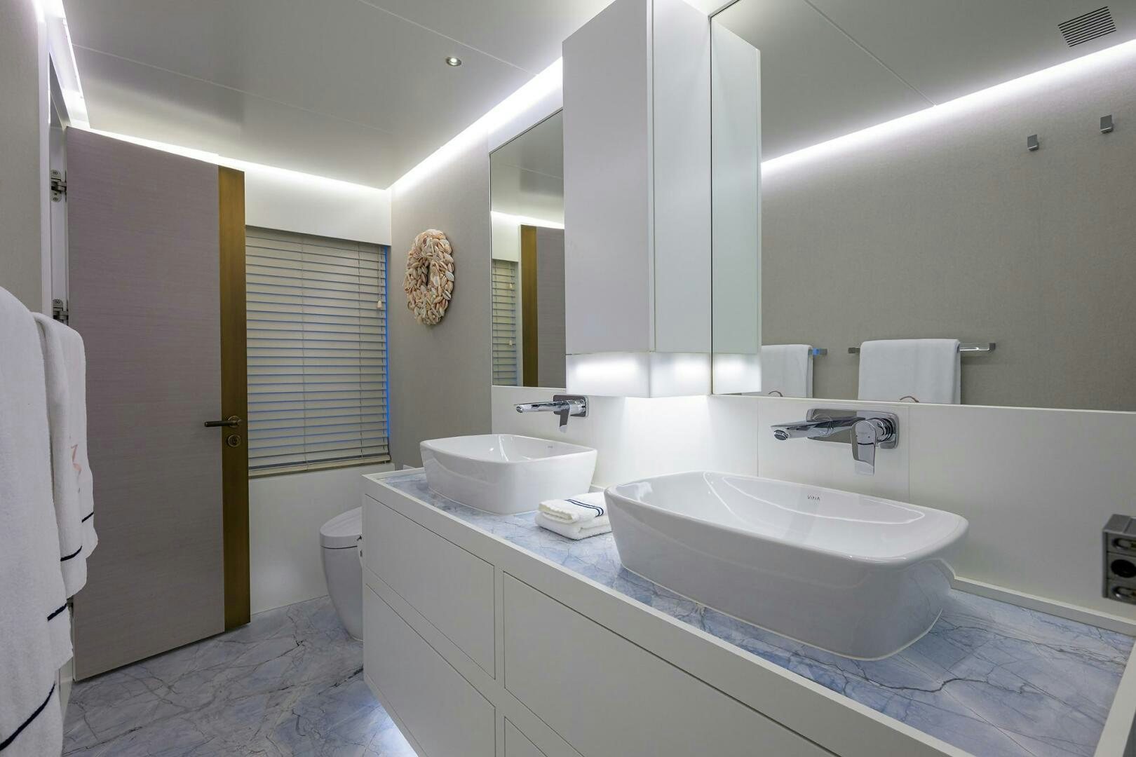 a bathroom with two sinks aboard AMORE Yacht for Sale