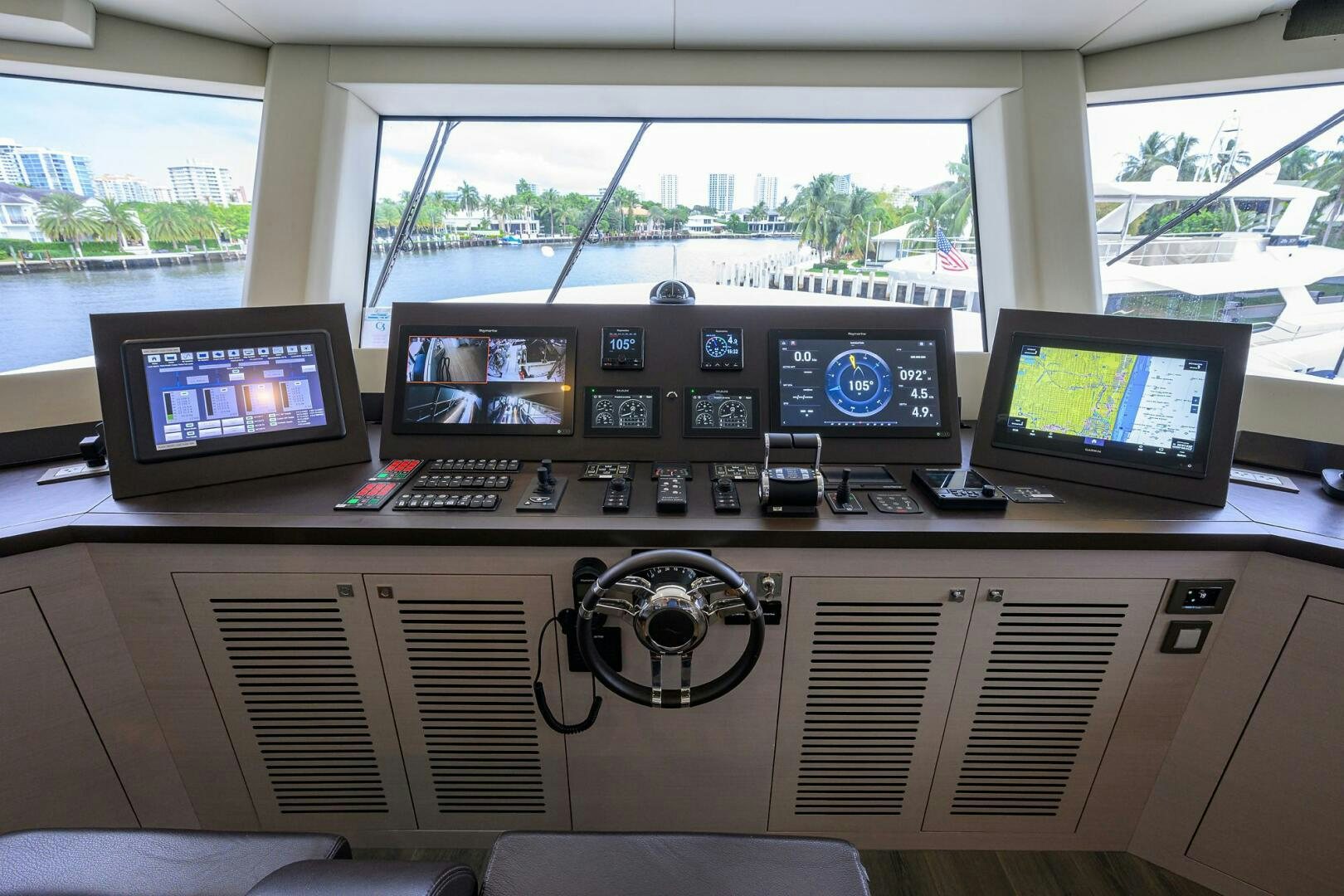 a control panel with several monitors aboard AMORE Yacht for Sale