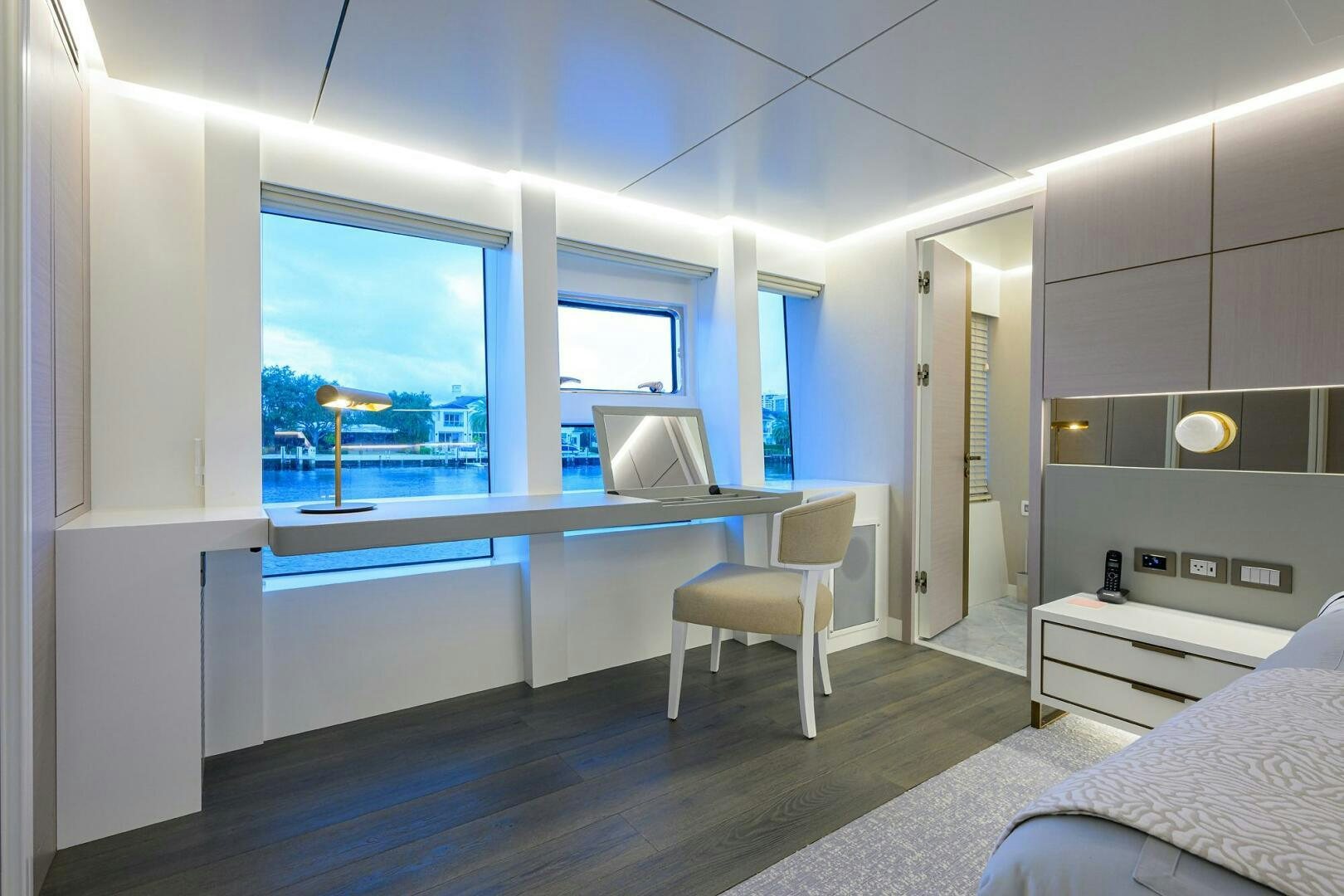 a room with a desk and a bed aboard AMORE Yacht for Sale