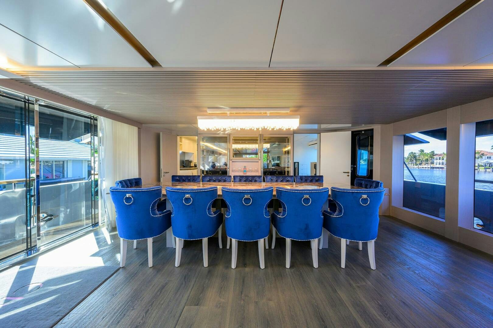 a long table with blue chairs aboard AMORE Yacht for Sale