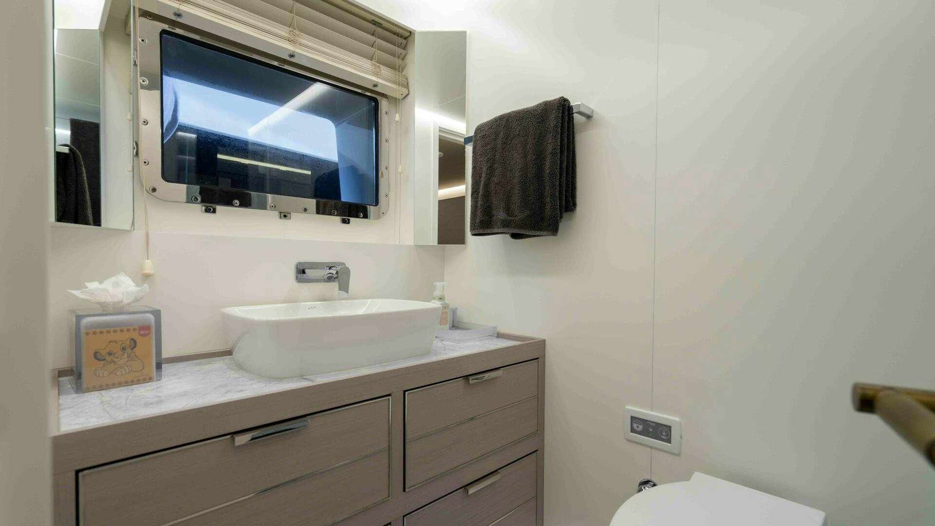 a bathroom with a sink and a tv aboard AMORE Yacht for Sale