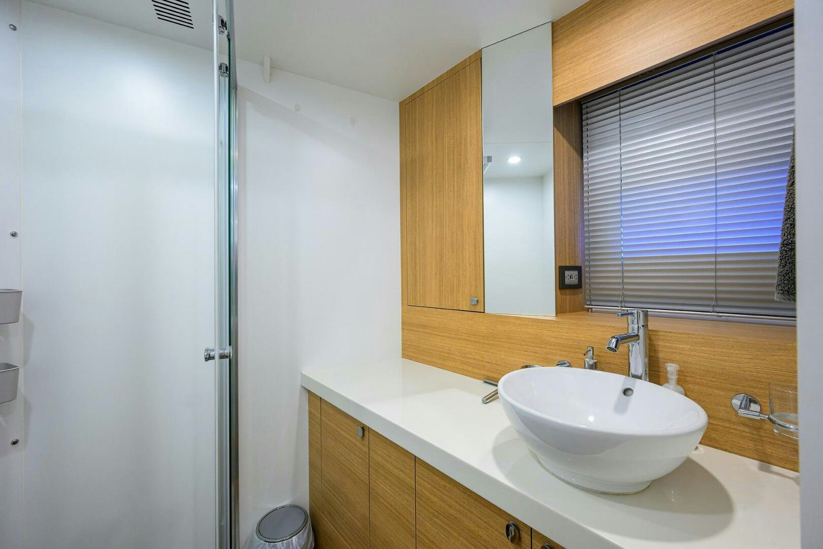 a bathroom with a sink and a shower unit aboard AMORE Yacht for Sale
