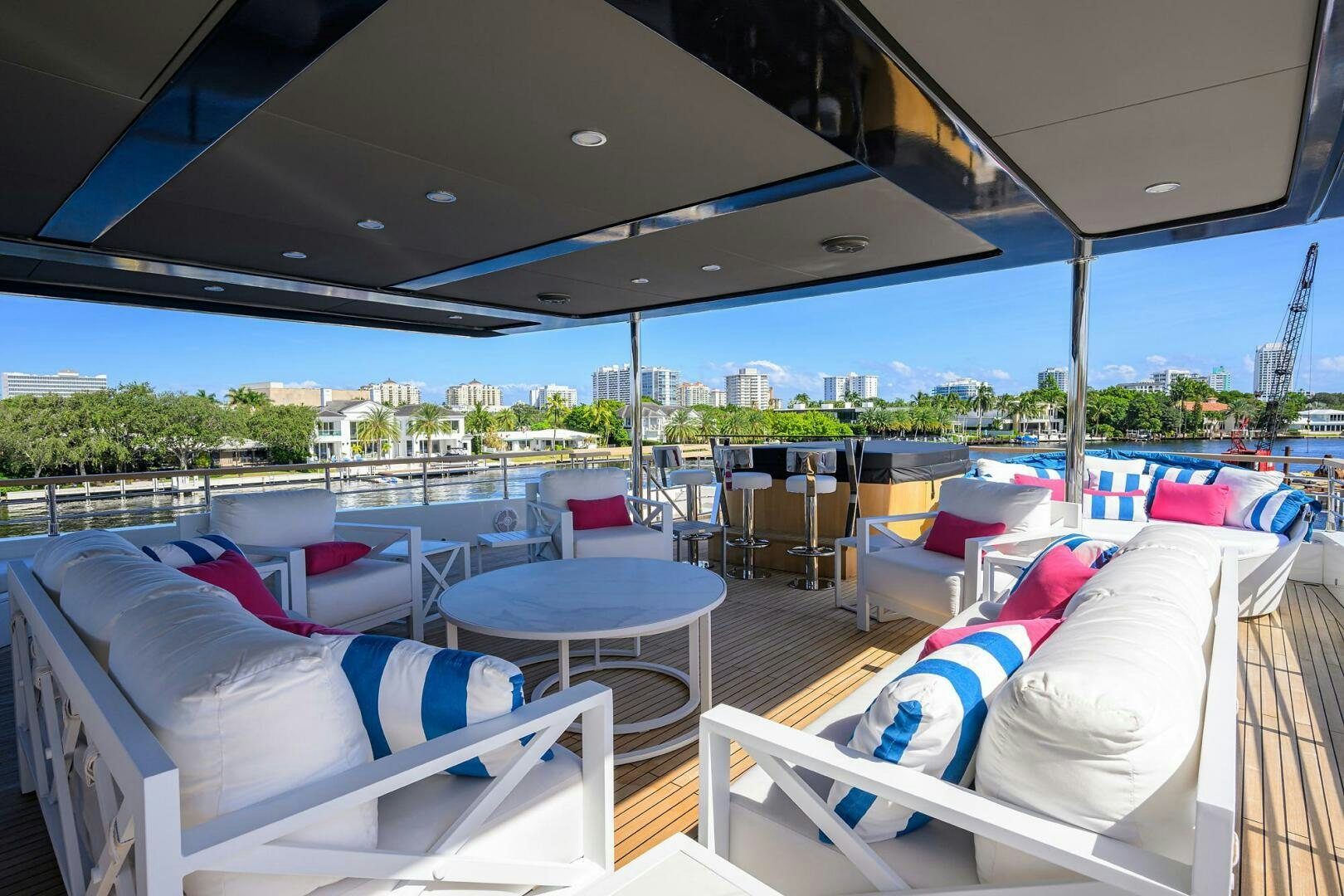 a deck with beds and a view of the city aboard AMORE Yacht for Sale