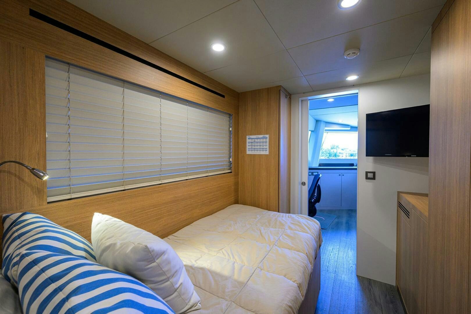 a bedroom with a bed and a television aboard AMORE Yacht for Sale
