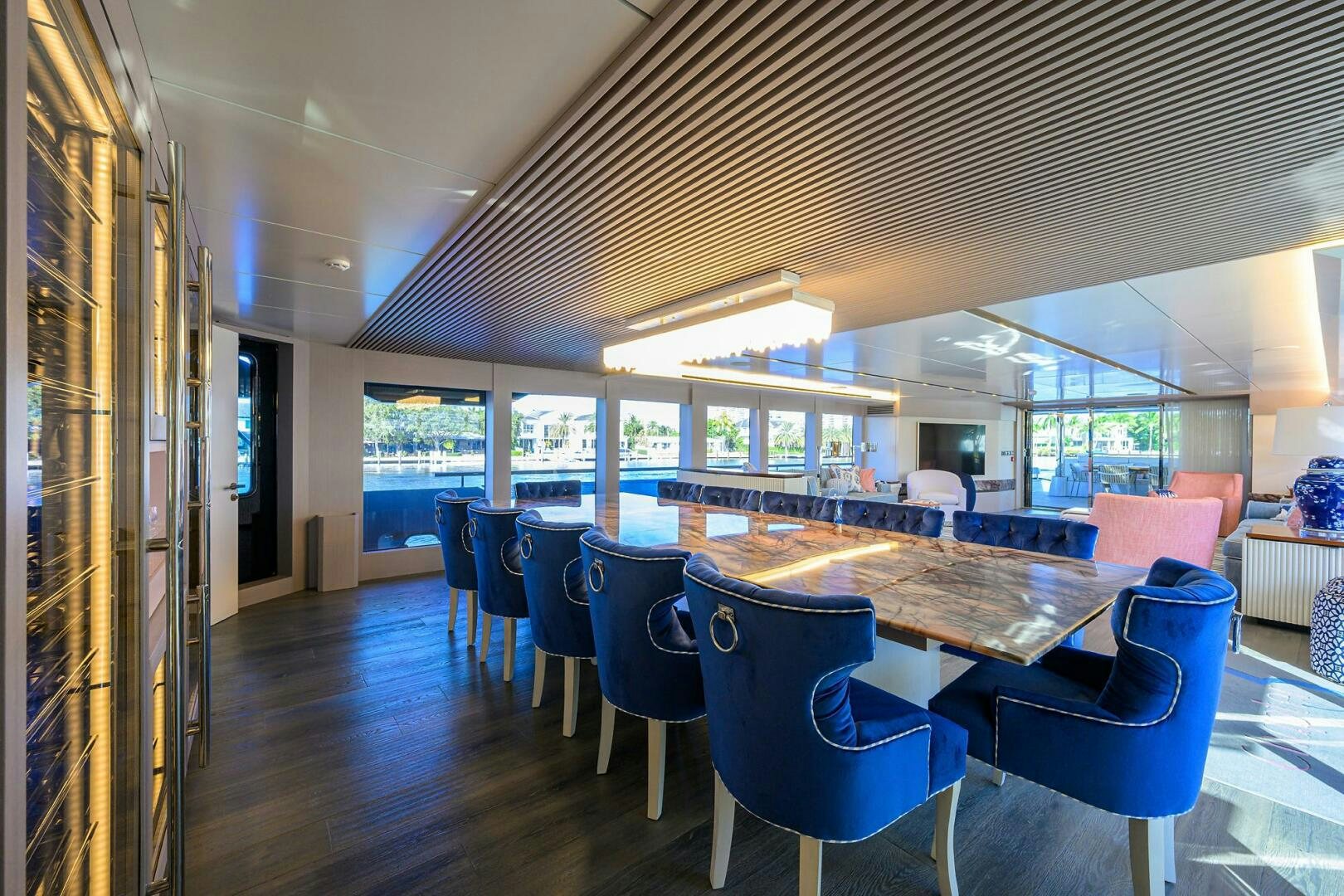 a large room with a table and chairs aboard AMORE Yacht for Sale