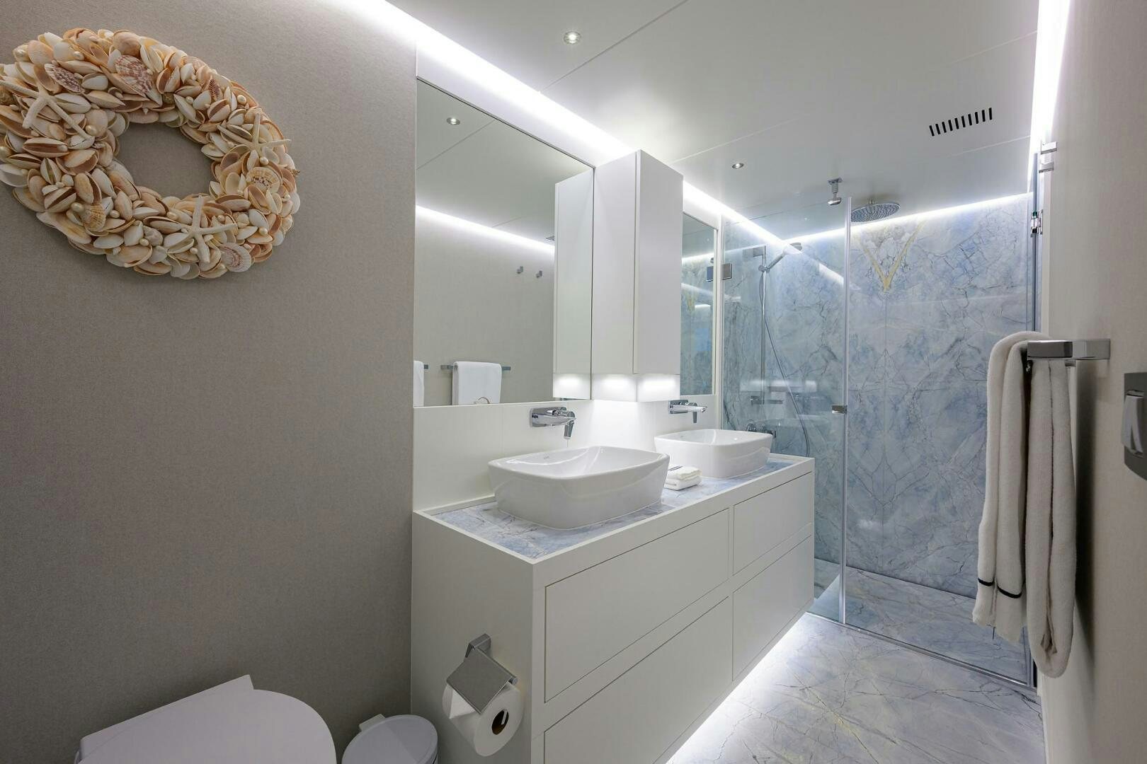 a bathroom with a sink and a mirror aboard AMORE Yacht for Sale