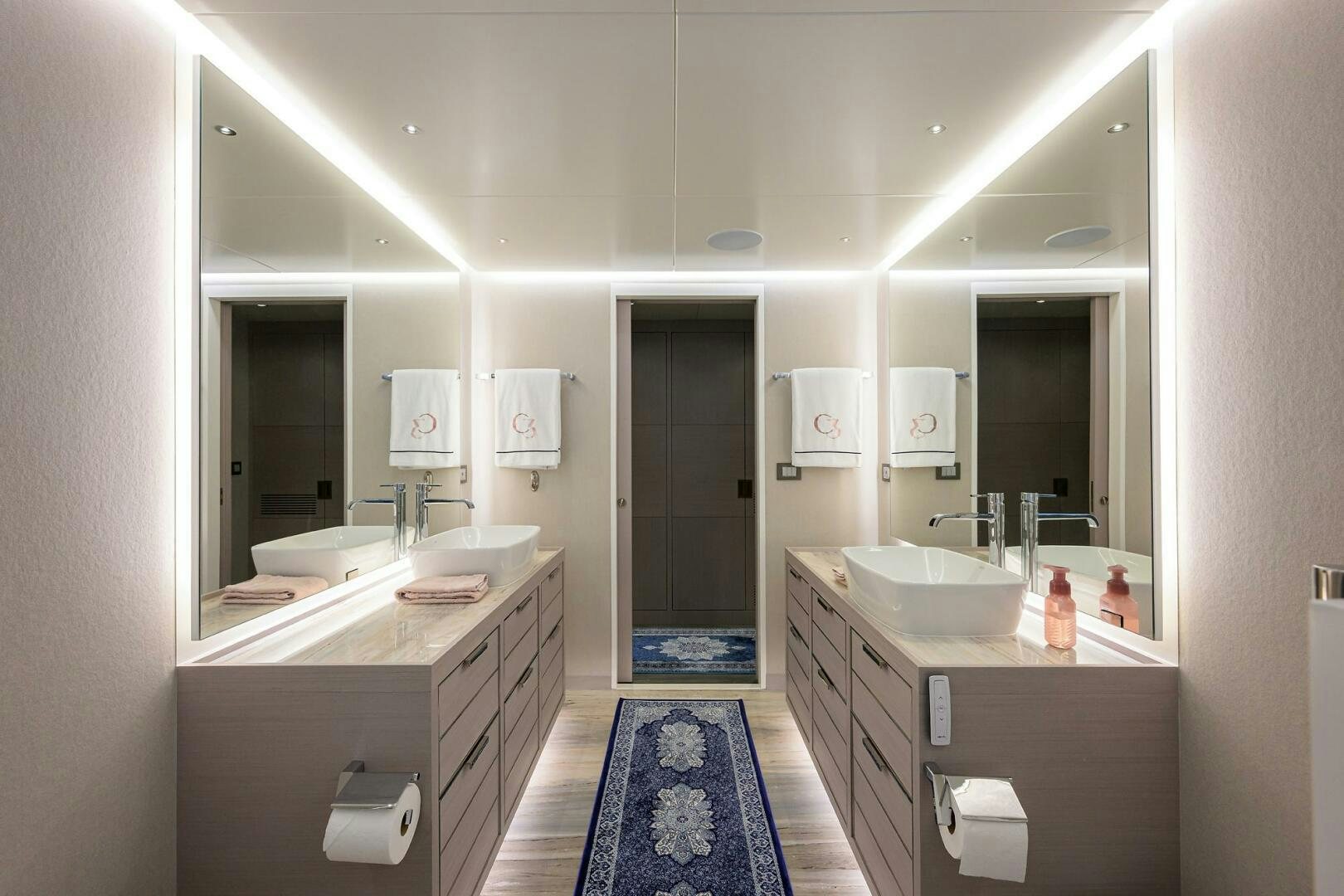 a bathroom with a sink and a mirror aboard AMORE Yacht for Sale