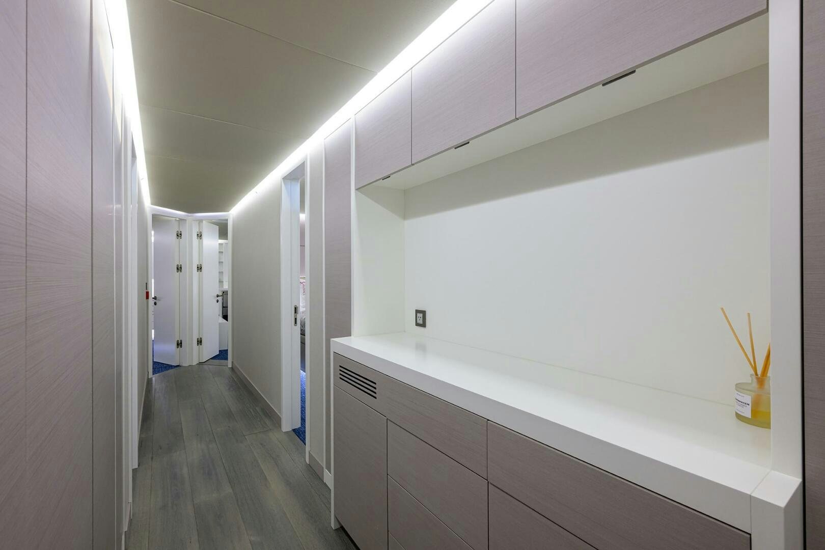 a hallway with white walls aboard AMORE Yacht for Sale