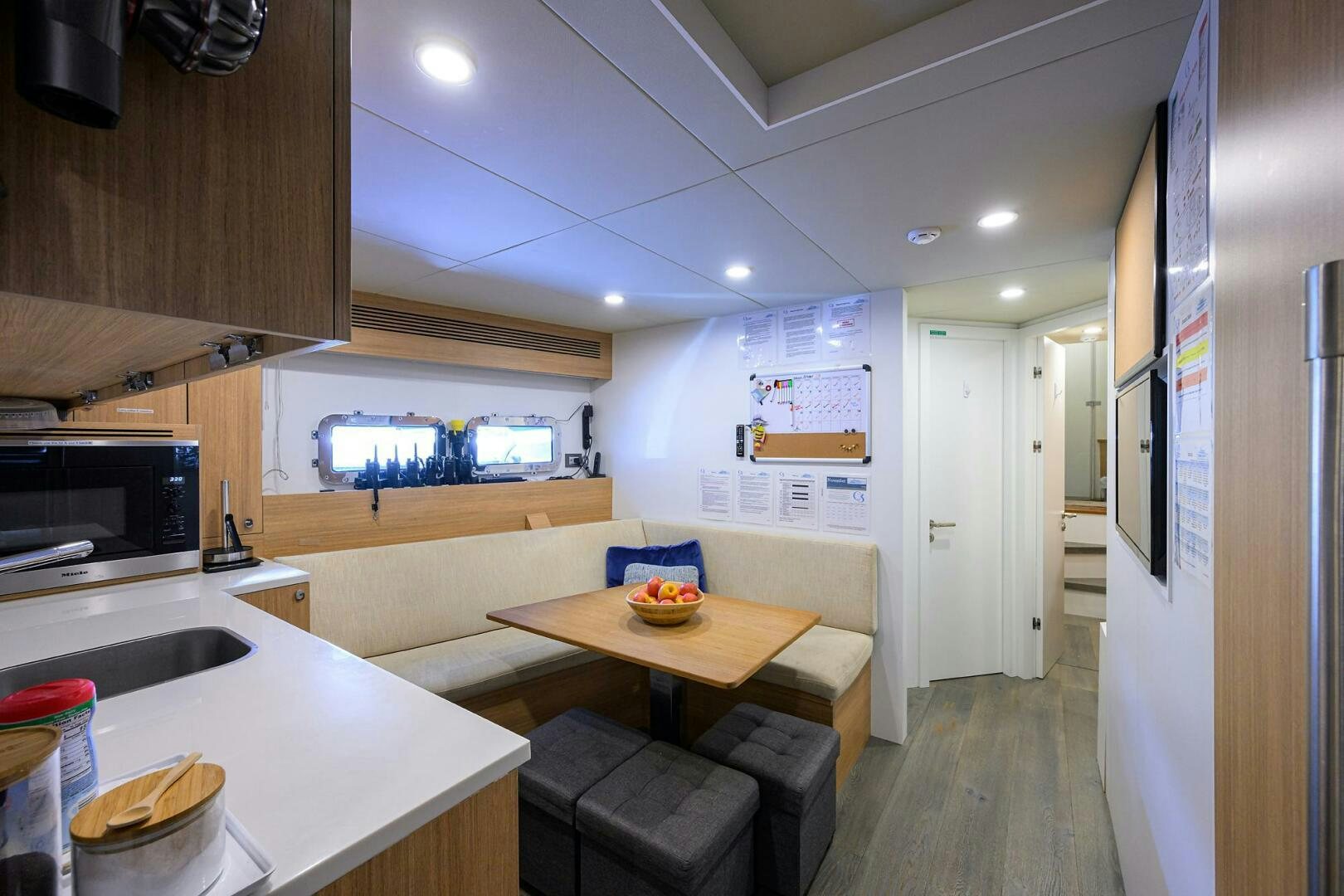 a kitchen with a table and chairs aboard AMORE Yacht for Sale