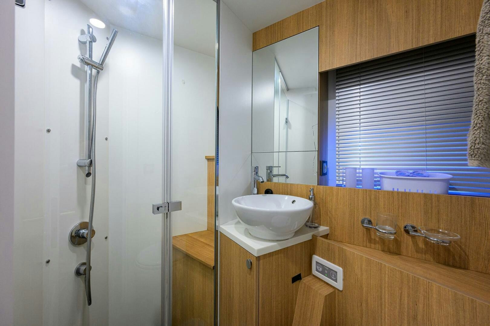 a bathroom with a shower unit and sink aboard AMORE Yacht for Sale