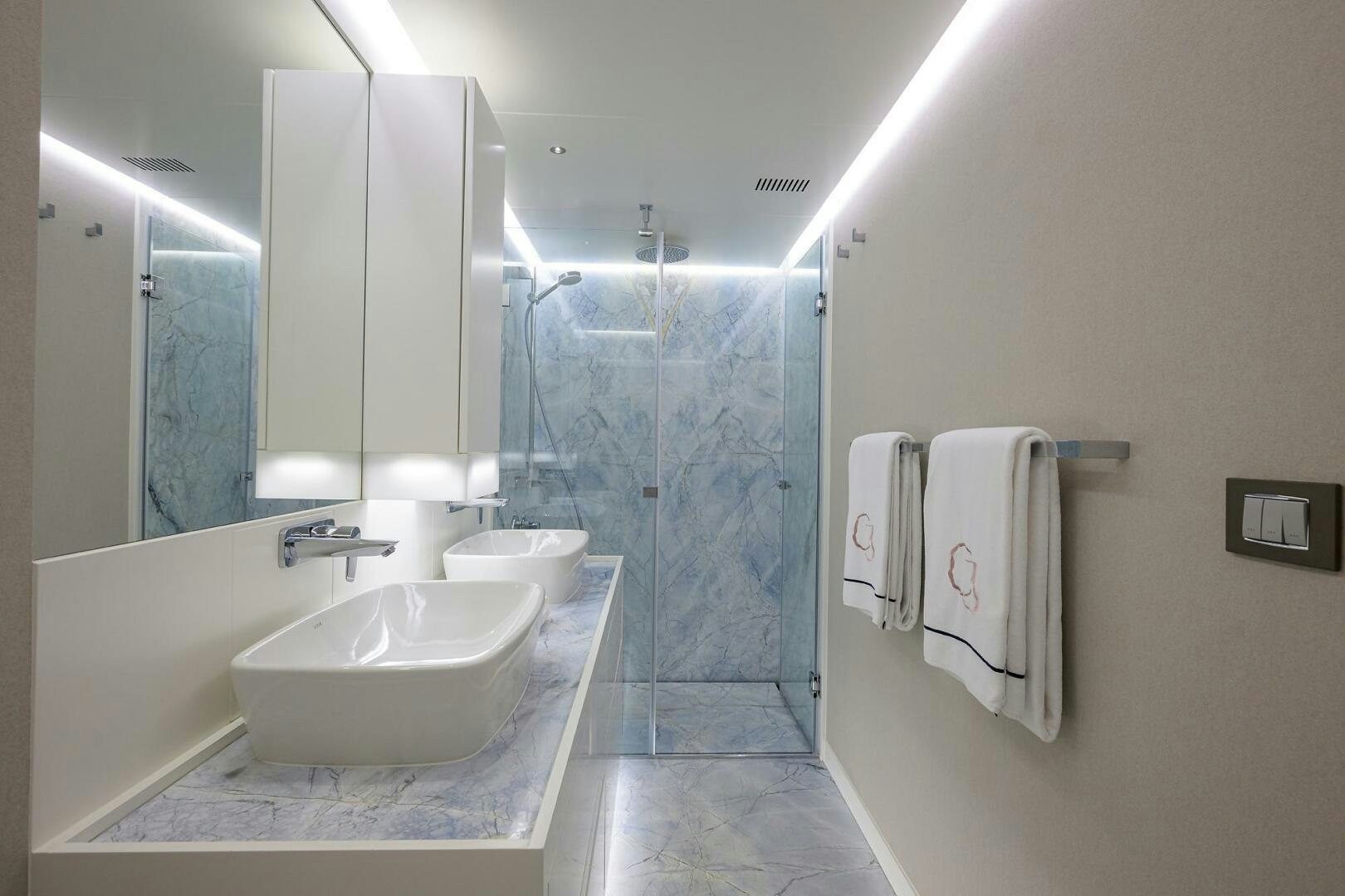 a bathroom with a sink and a mirror aboard AMORE Yacht for Sale