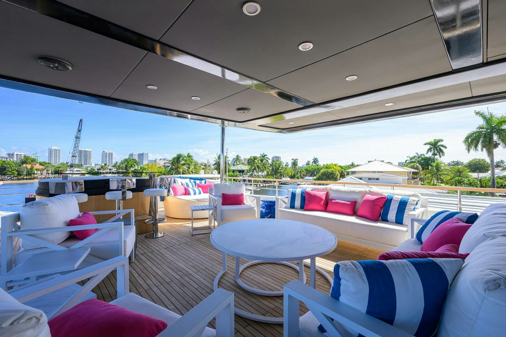 a deck with chairs and tables aboard AMORE Yacht for Sale
