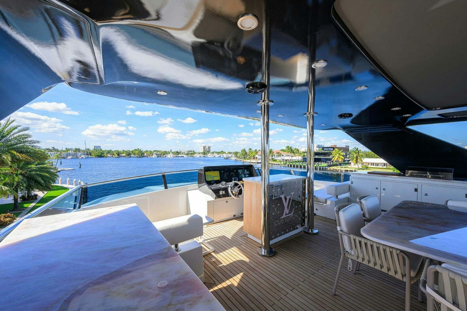 a deck with a pool and a deck with chairs and tables aboard AMORE Yacht for Sale