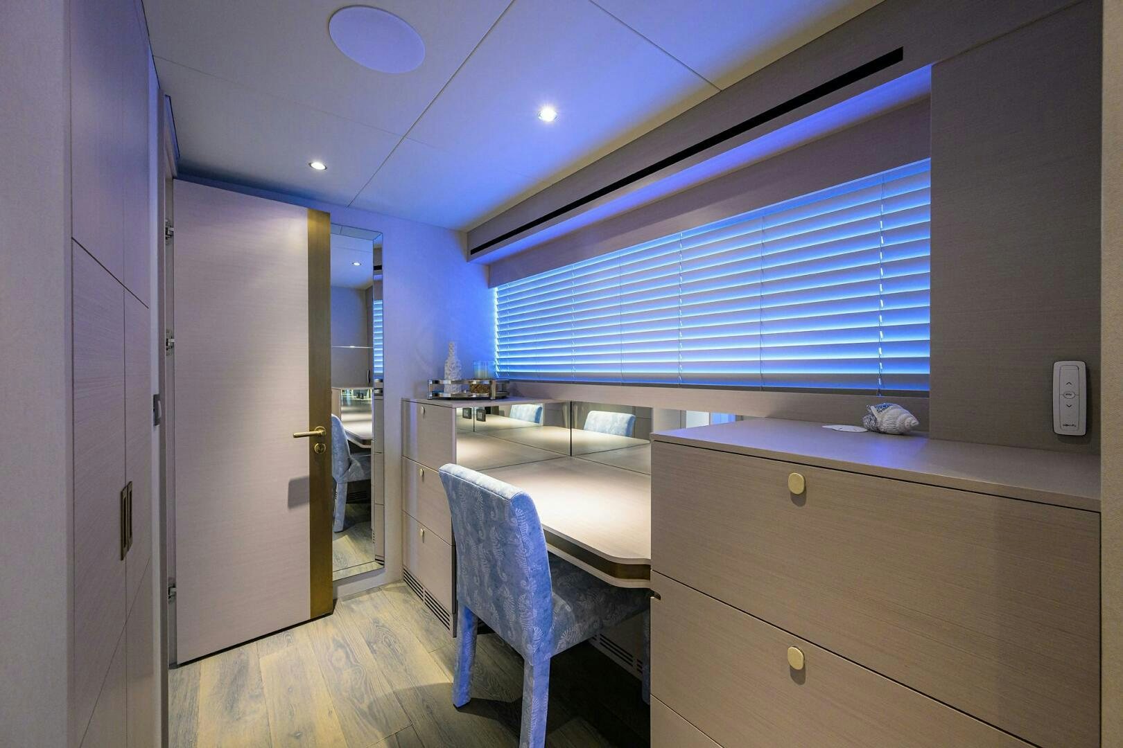 a kitchen with a blue chair aboard AMORE Yacht for Sale