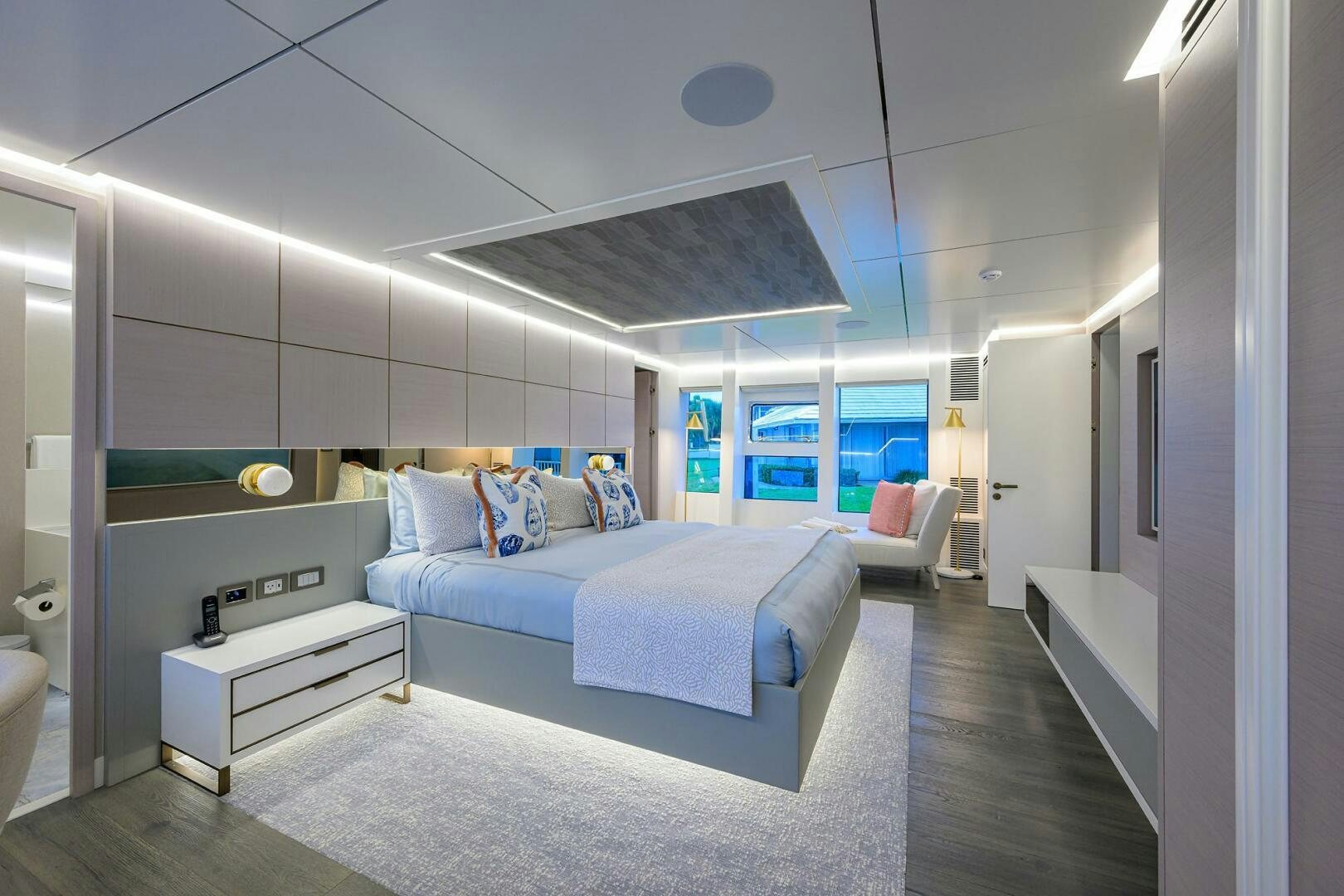 a bedroom with a bed and a desk aboard AMORE Yacht for Sale