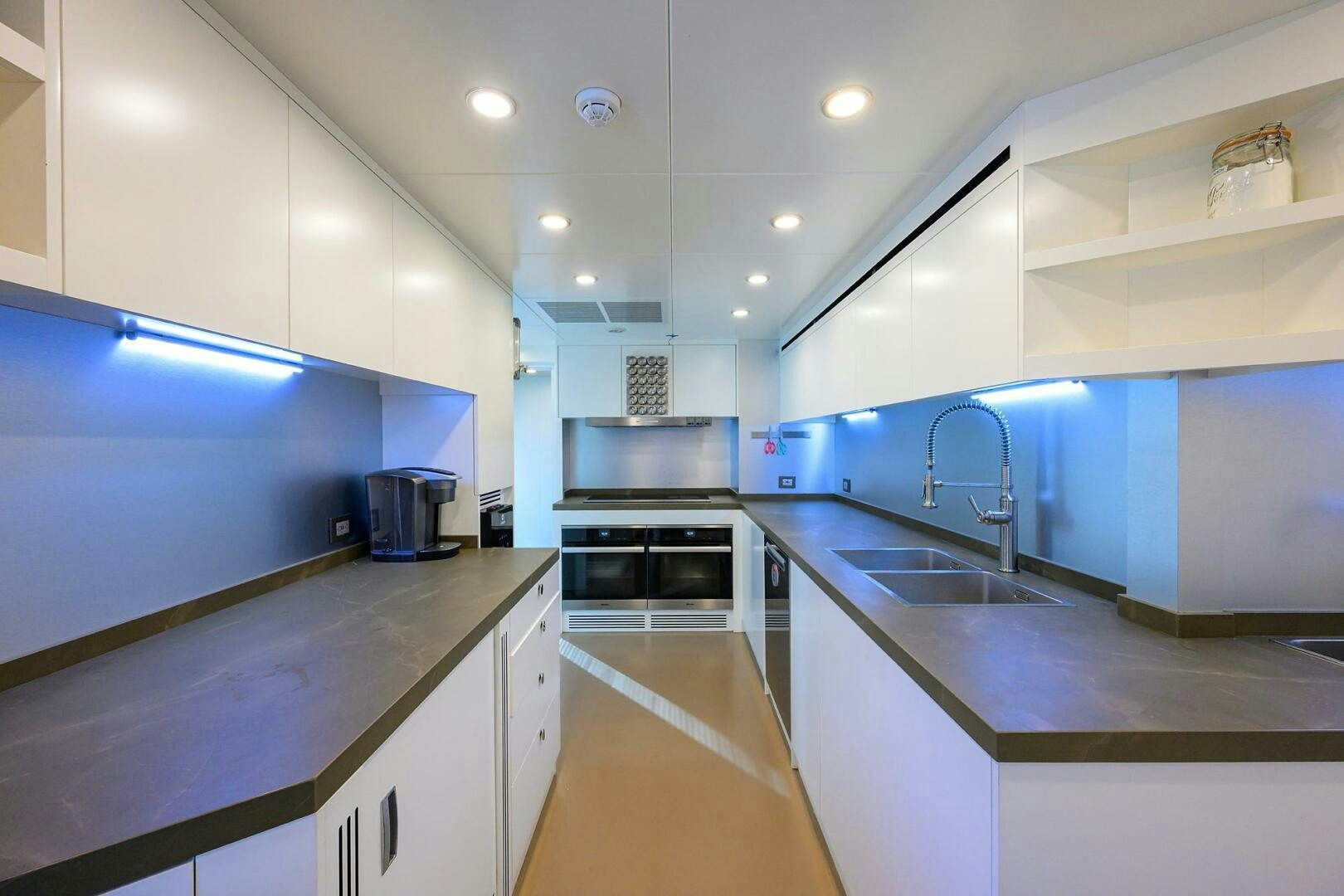 a kitchen with a sink and cabinets aboard AMORE Yacht for Sale