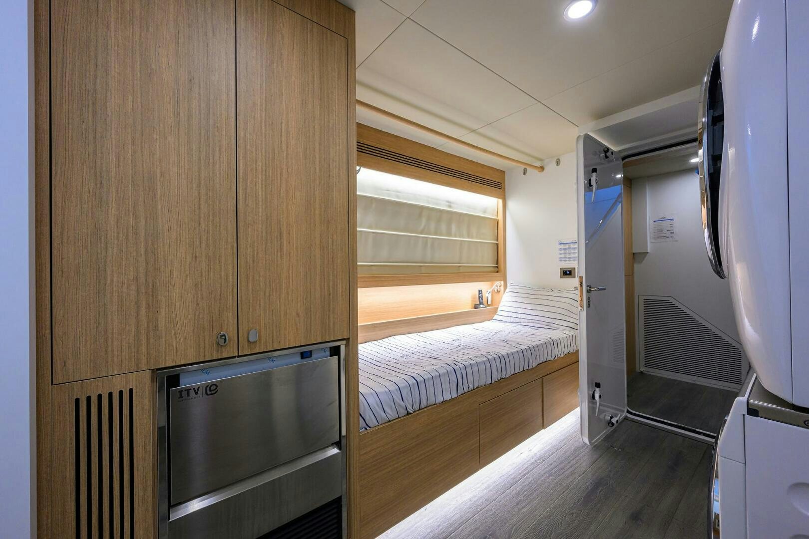 a bedroom with a bed and a microwave aboard AMORE Yacht for Sale