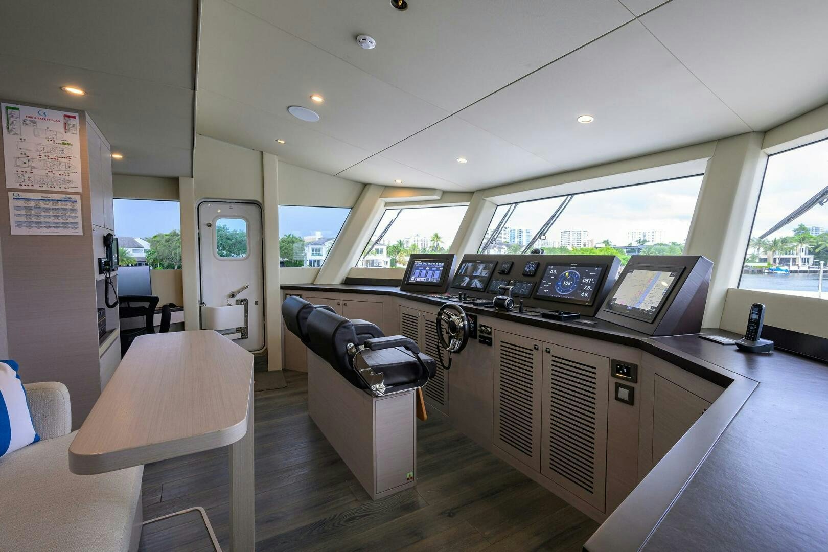 a room with a desk and chairs aboard AMORE Yacht for Sale