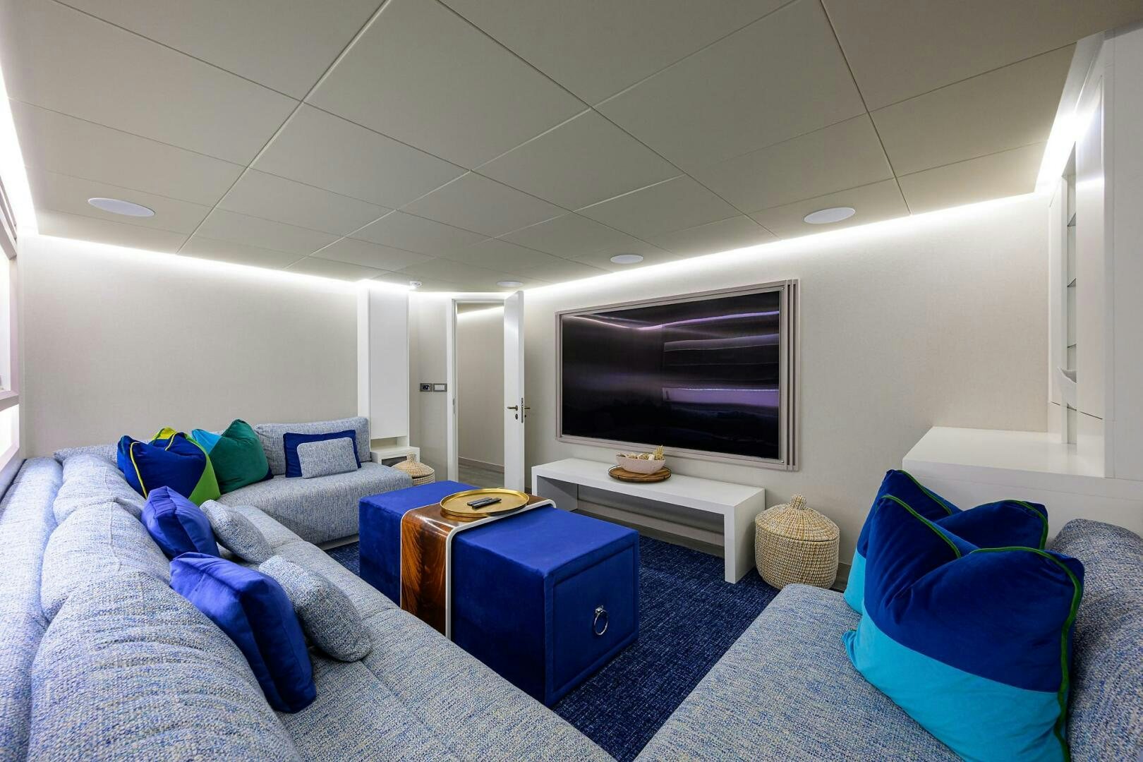 a room with a blue bed and a blue chair aboard AMORE Yacht for Sale