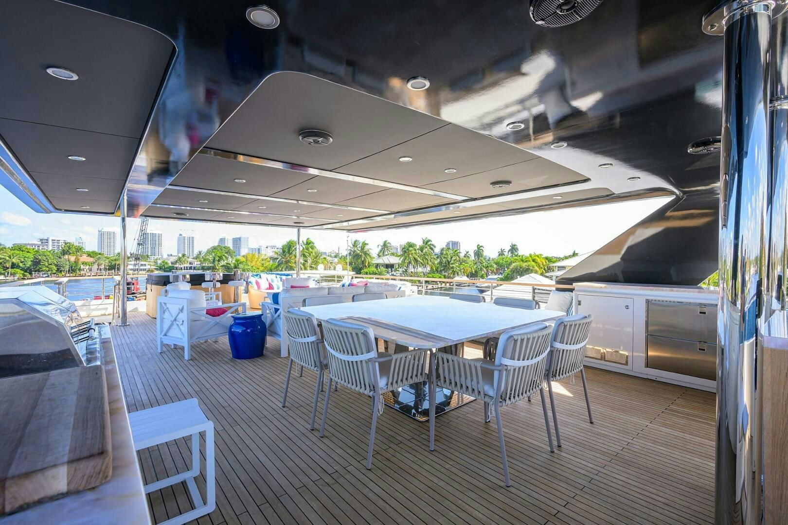 a patio with tables and chairs aboard AMORE Yacht for Sale