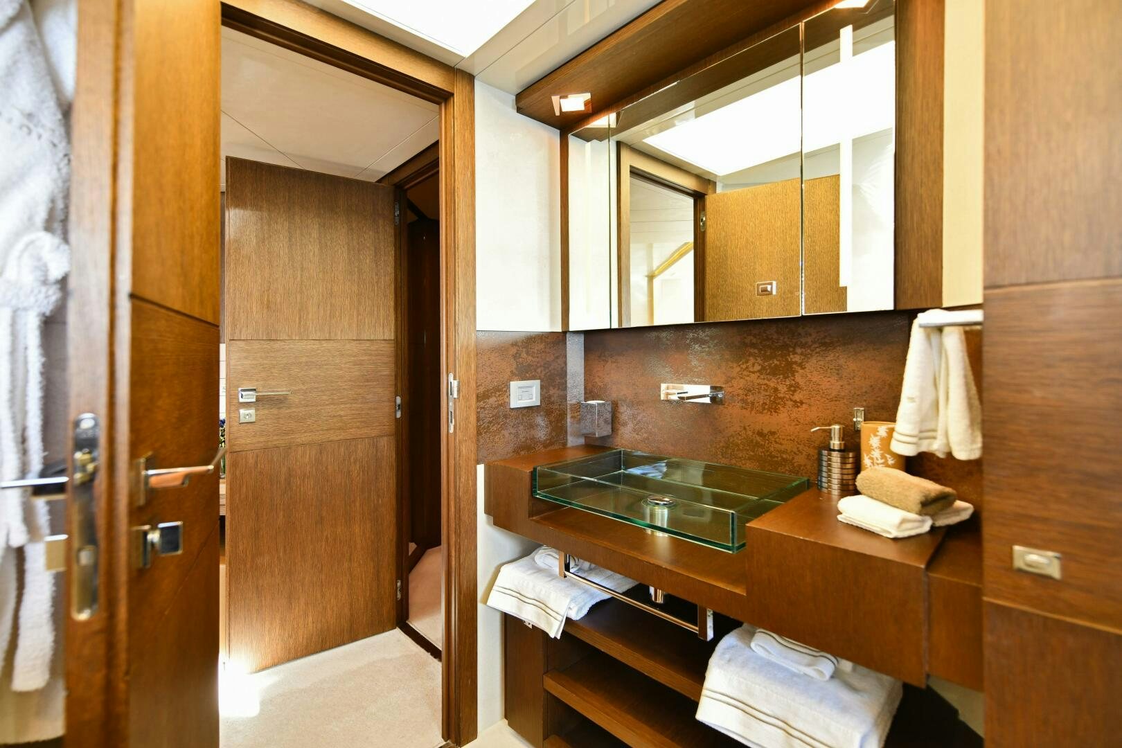 a bathroom with a sink and mirror aboard INFINITAS Yacht for Sale