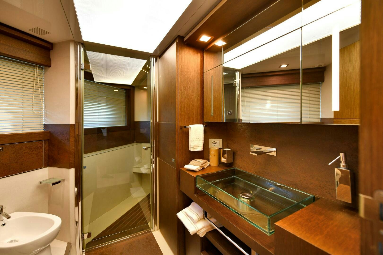 a bathroom with a glass shower aboard INFINITAS Yacht for Sale