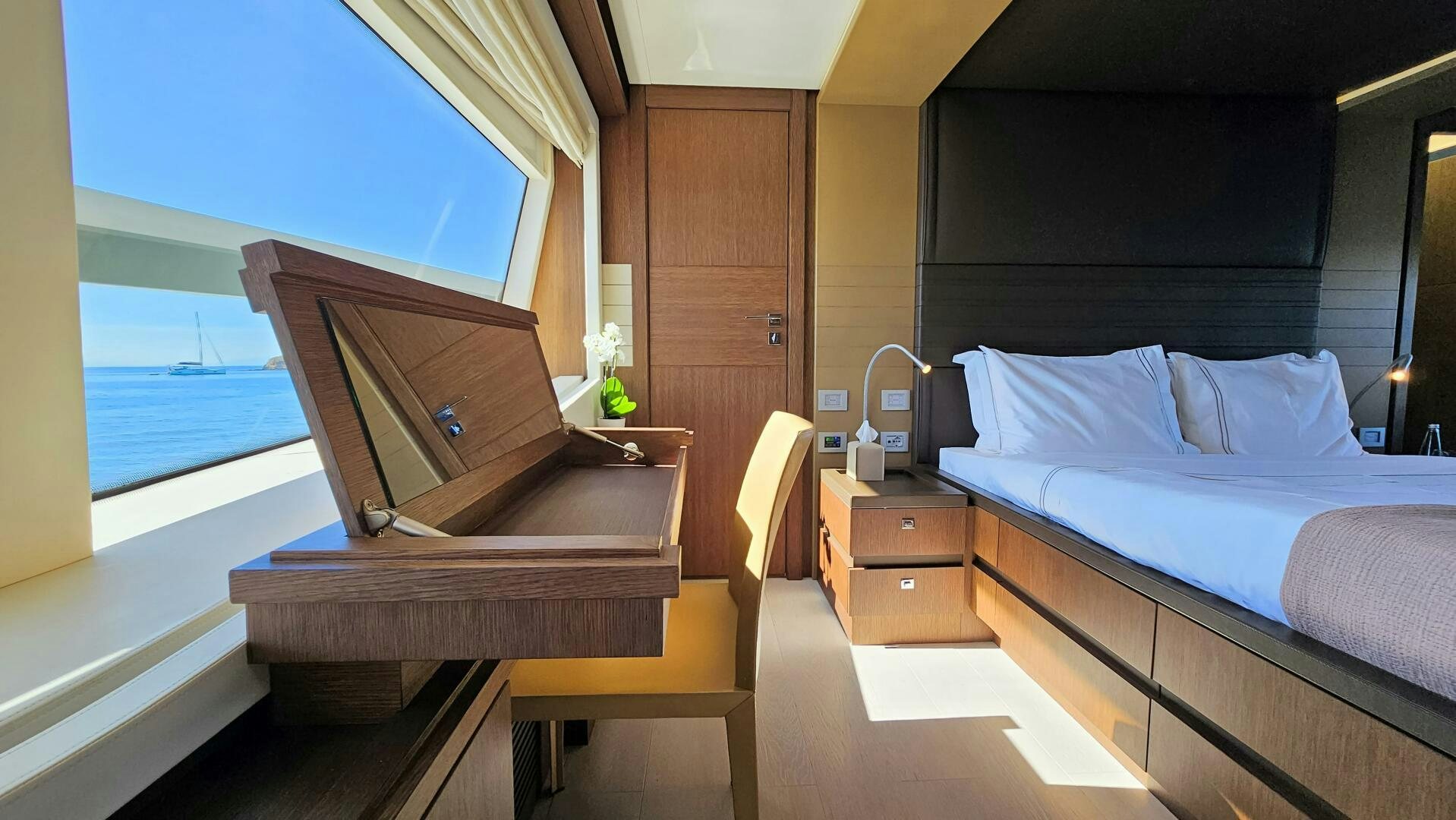a room with a bed and a piano aboard INFINITAS Yacht for Sale