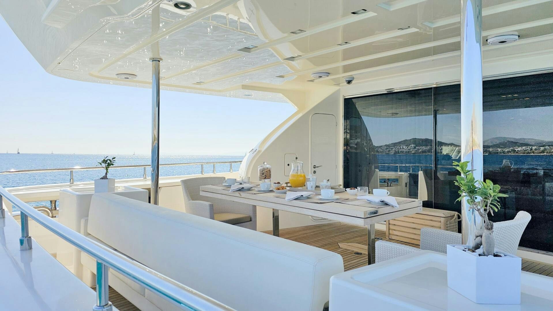 a room with a table and chairs aboard INFINITAS Yacht for Sale