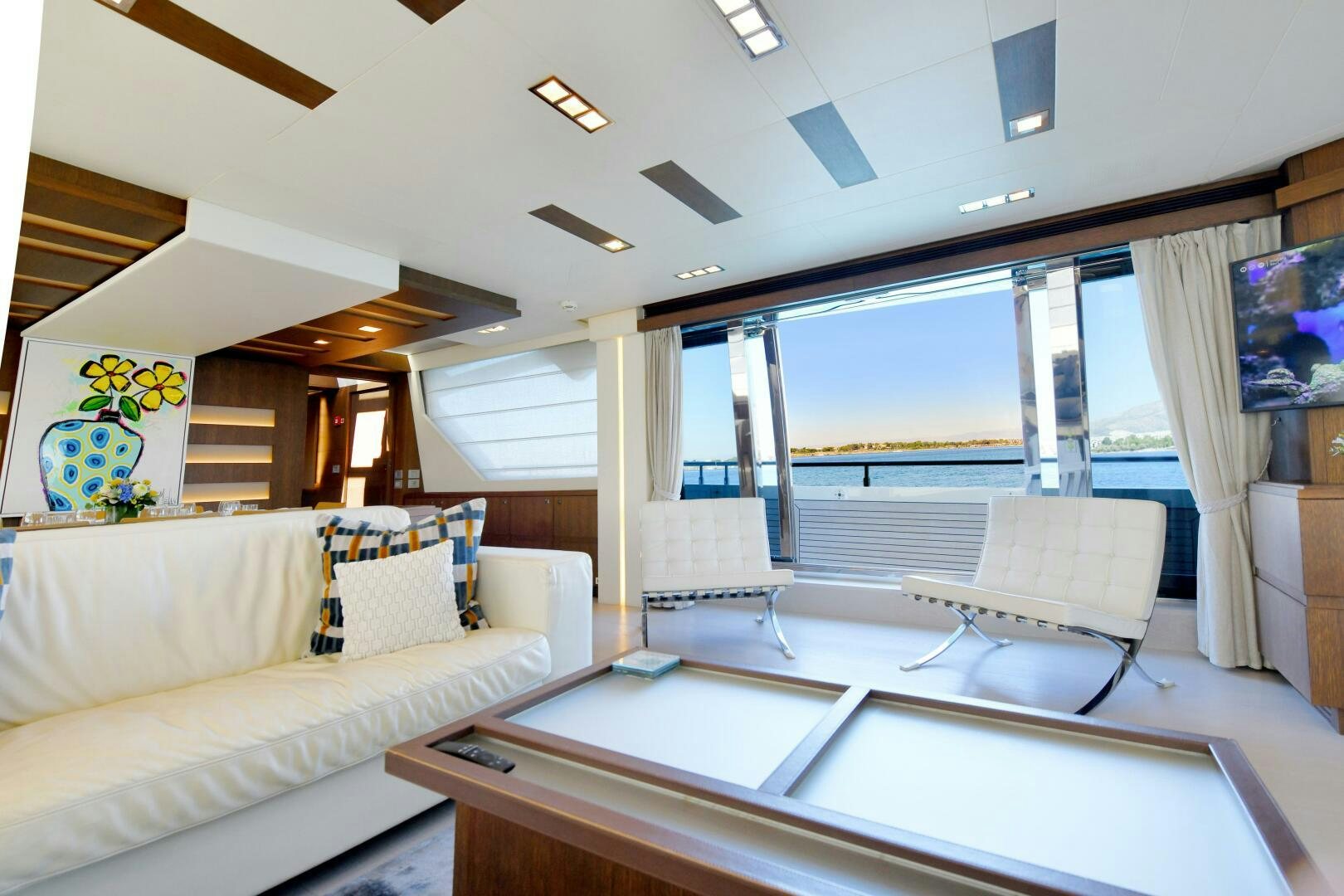 a room with a couch and a table aboard INFINITAS Yacht for Sale