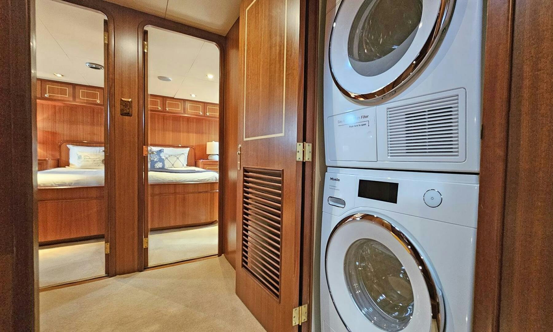 a room with a bed and a washer aboard SHAMROCK Yacht for Sale