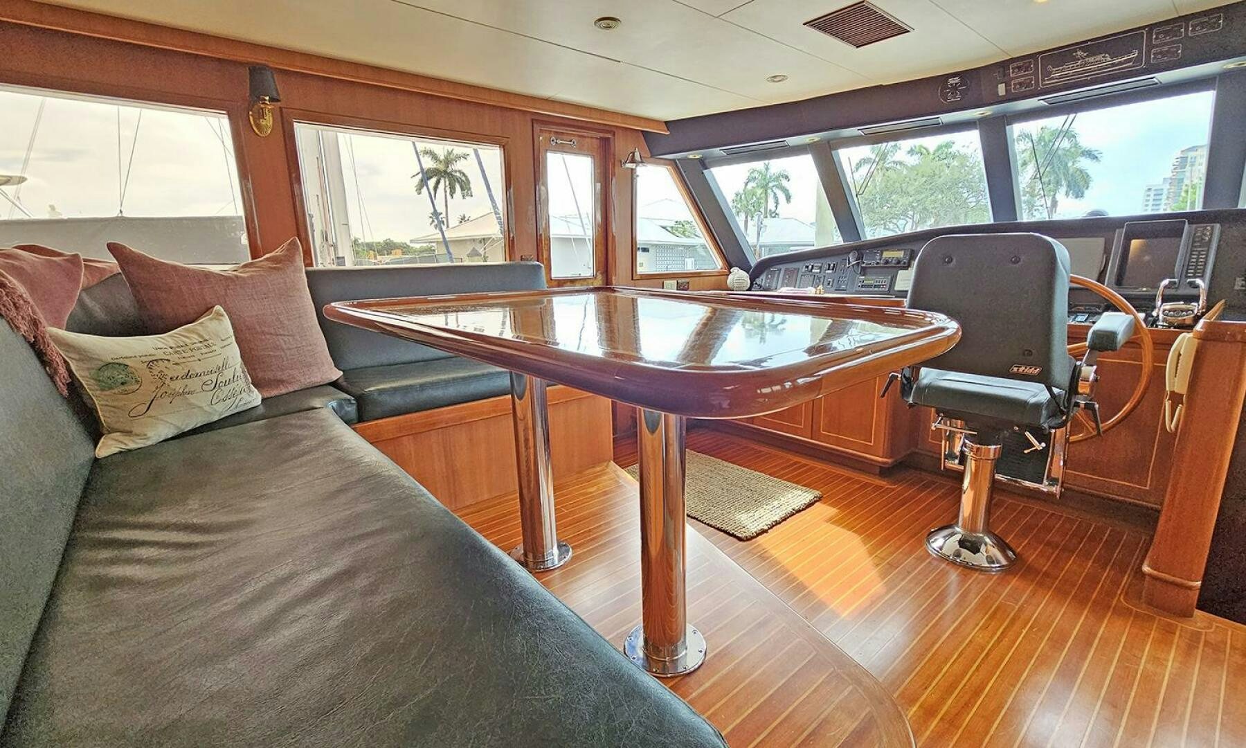 a table and a couch in a room with a window aboard SHAMROCK Yacht for Sale