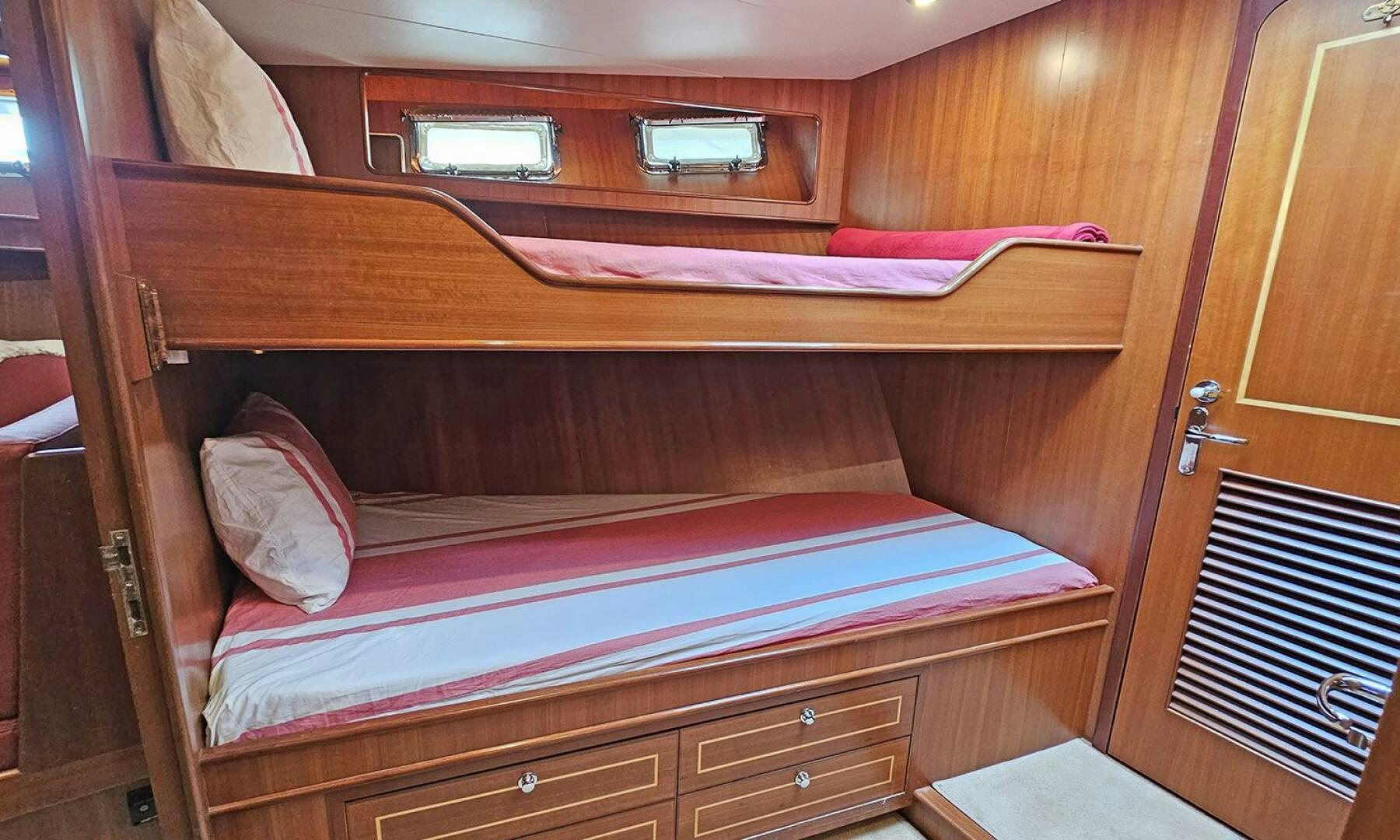 a bed with red sheets aboard SHAMROCK Yacht for Sale