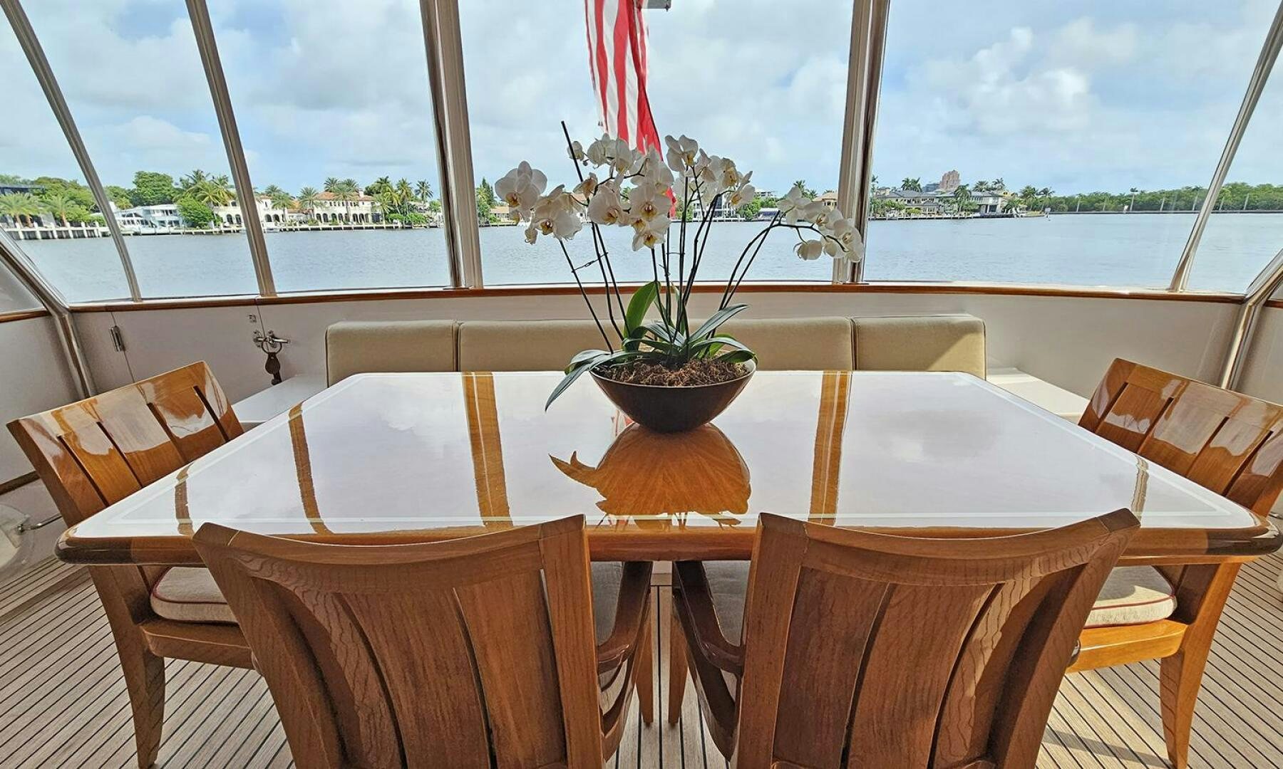 a table with chairs and a plant on it aboard SHAMROCK Yacht for Sale