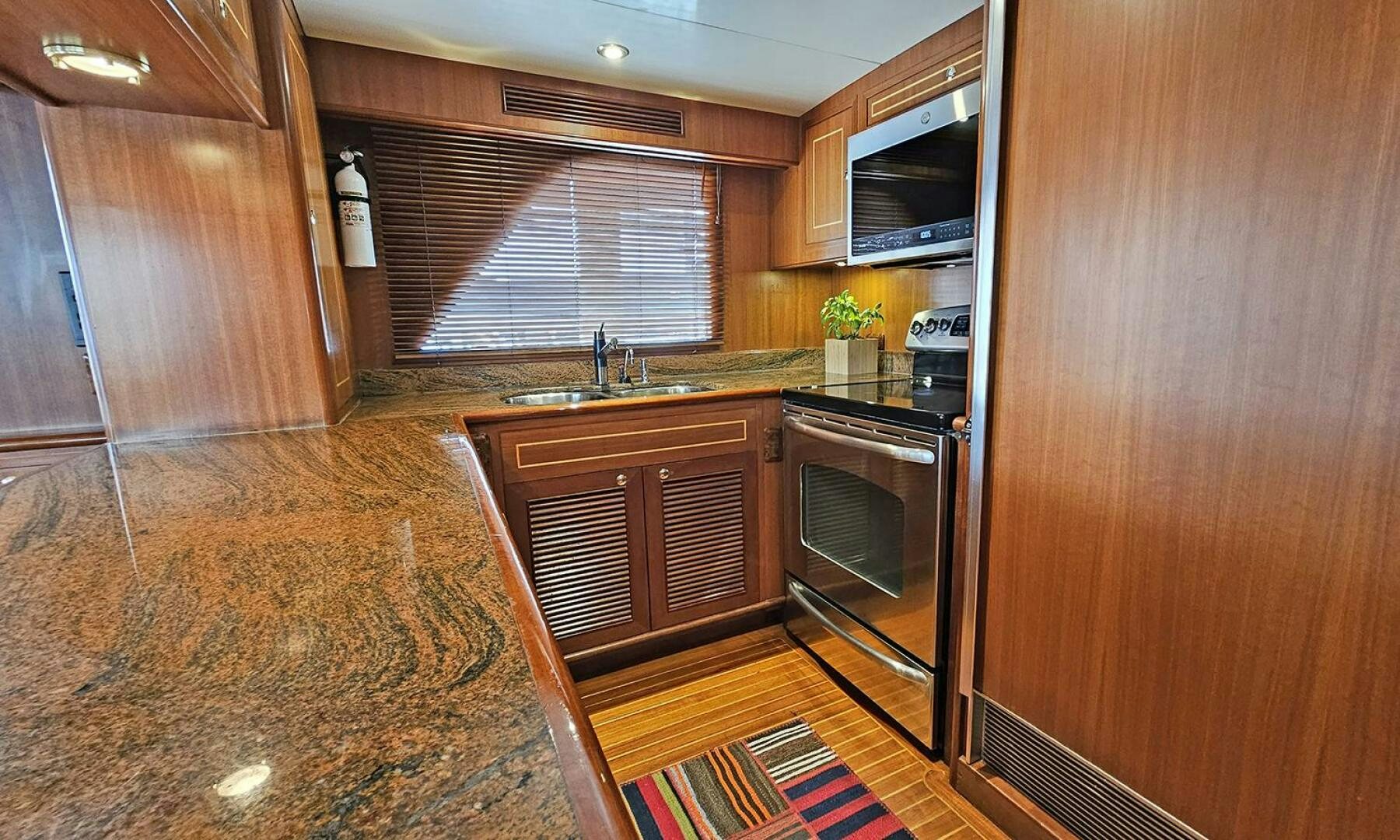 a kitchen with wooden cabinets aboard SHAMROCK Yacht for Sale
