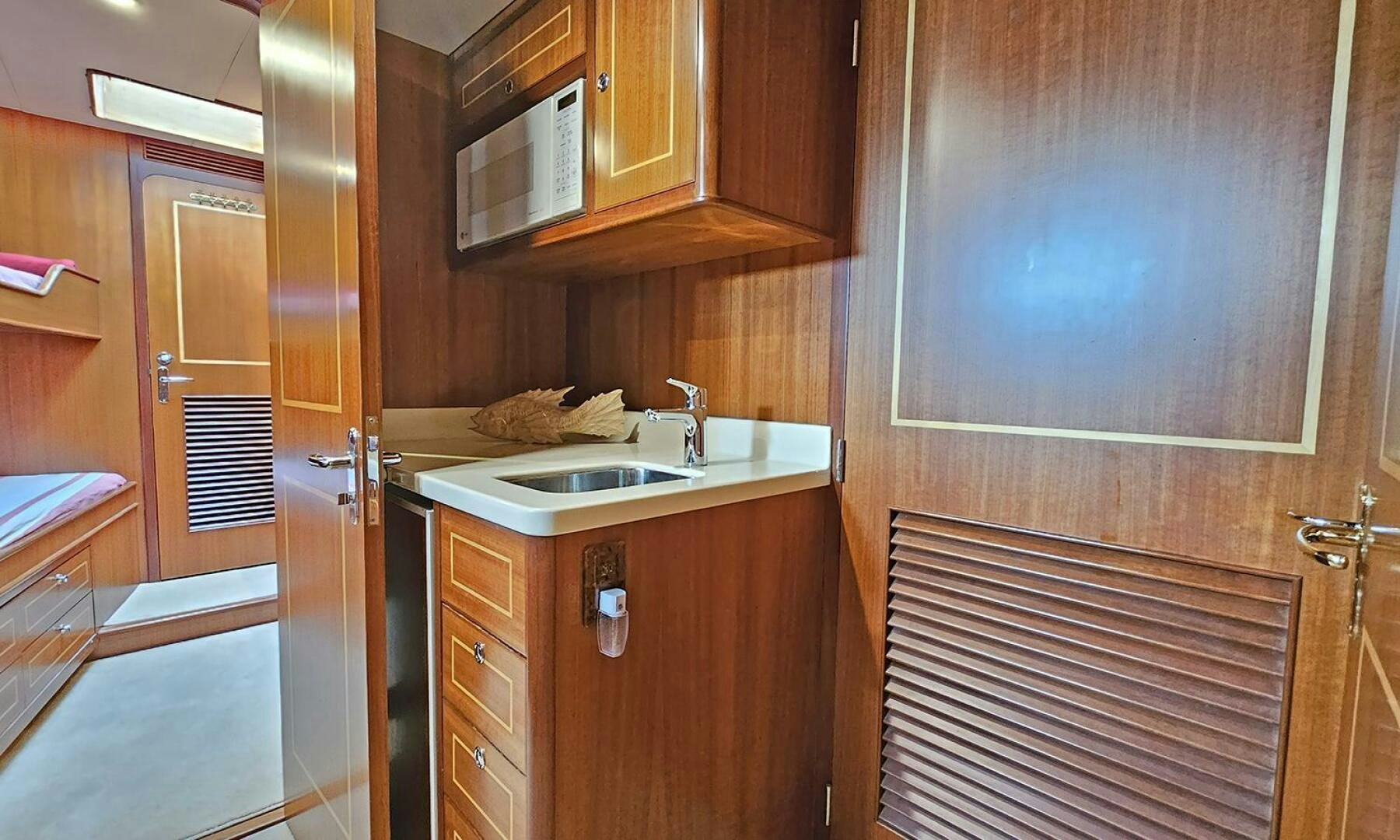 a kitchen with wooden cabinets aboard SHAMROCK Yacht for Sale