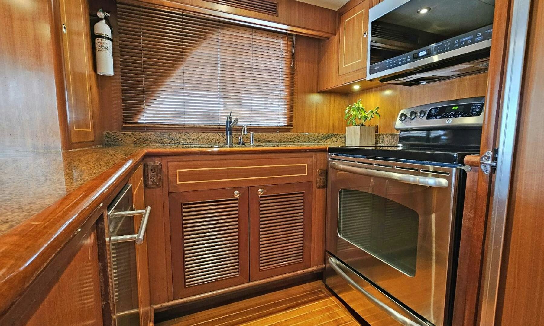 a kitchen with wooden cabinets aboard SHAMROCK Yacht for Sale