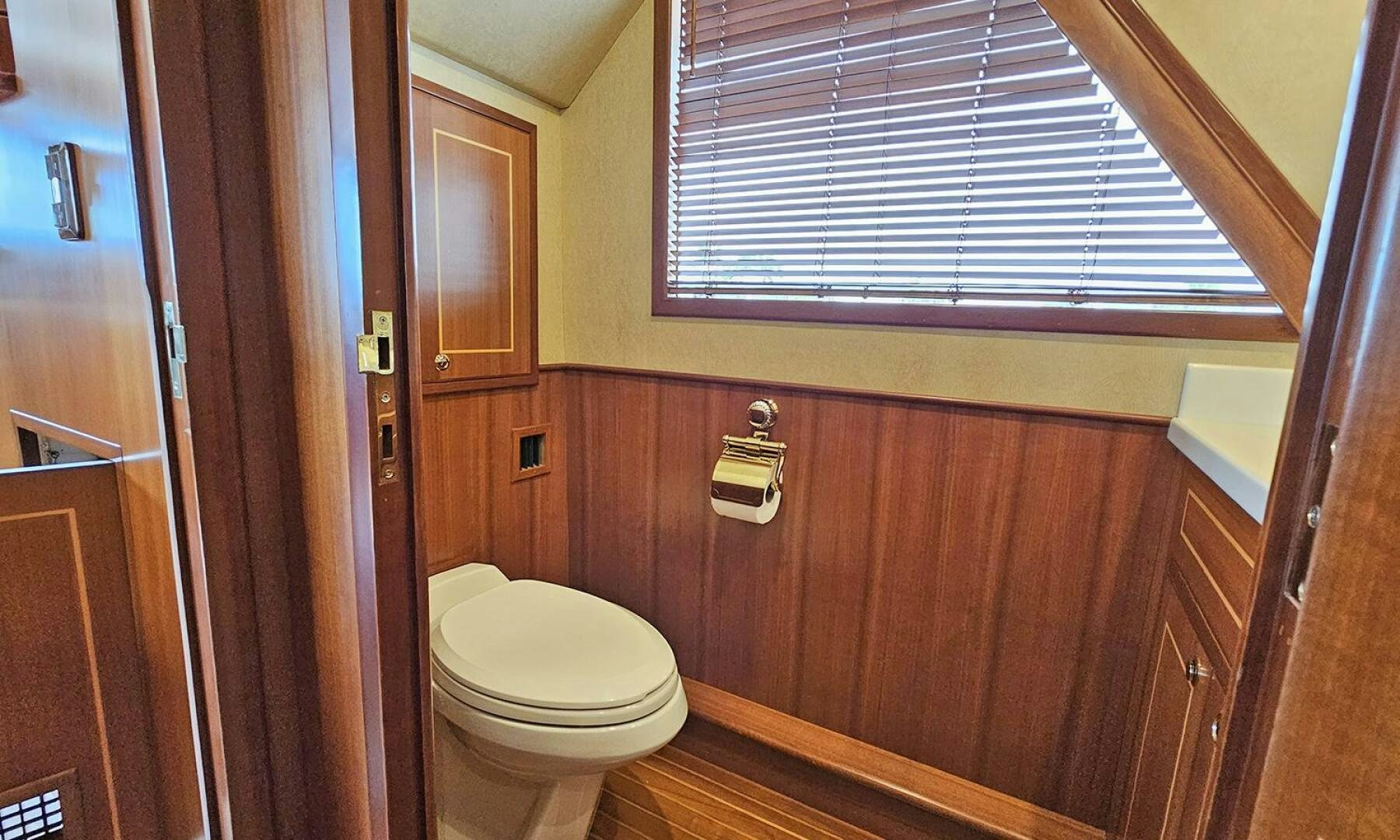 a bathroom with a toilet and a window aboard SHAMROCK Yacht for Sale
