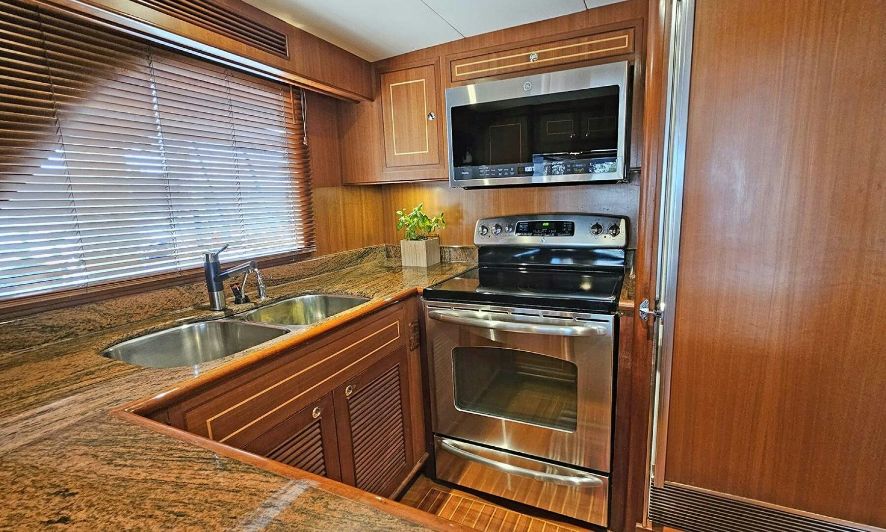 a kitchen with wooden cabinets aboard SHAMROCK Yacht for Sale