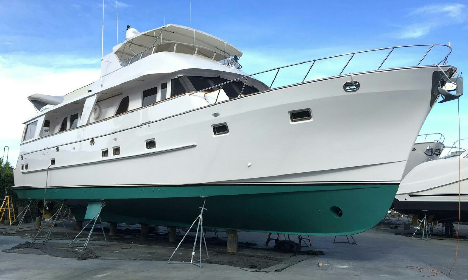 a white yacht on a dock aboard SHAMROCK Yacht for Sale