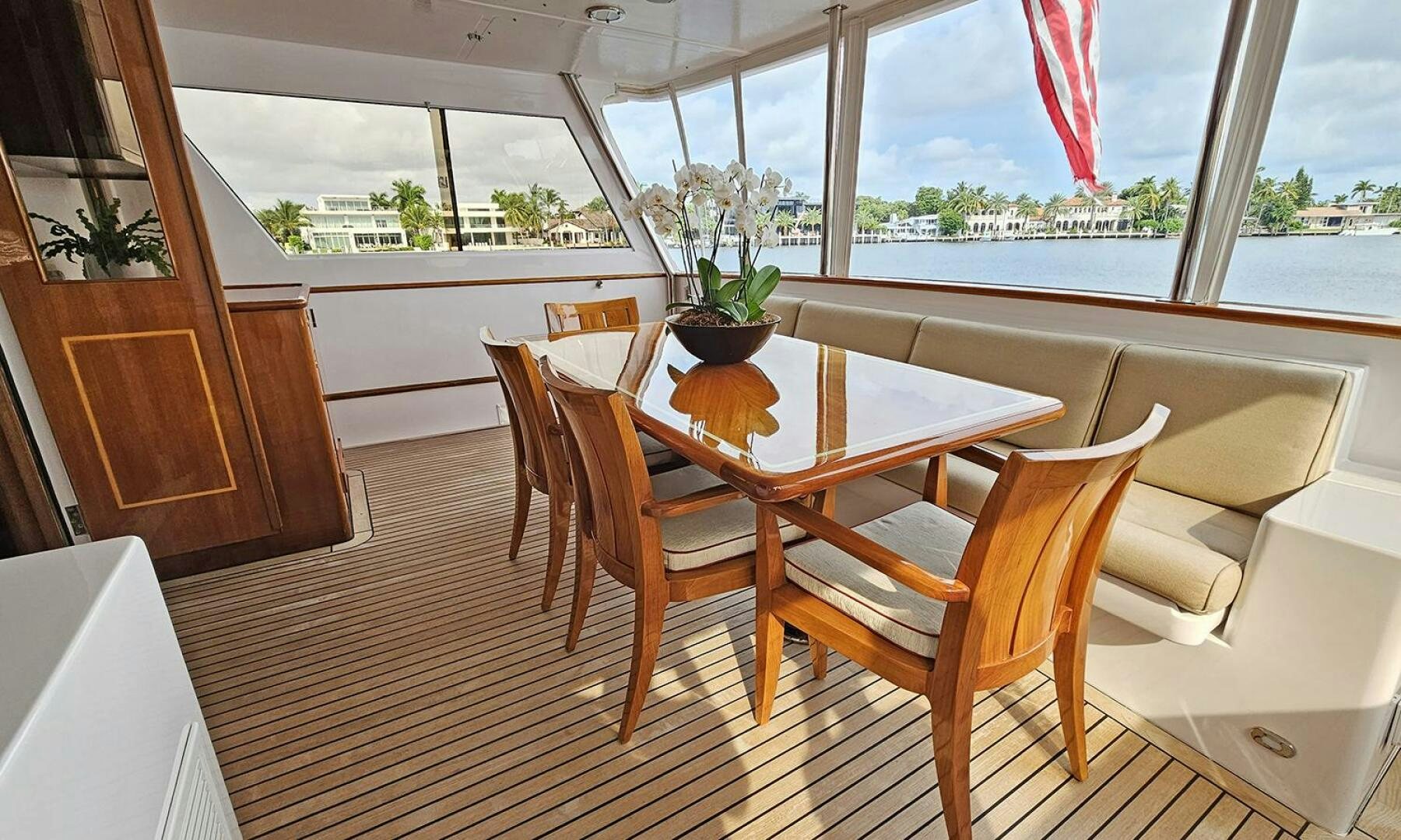 a dining table and chairs in a room with a window aboard SHAMROCK Yacht for Sale
