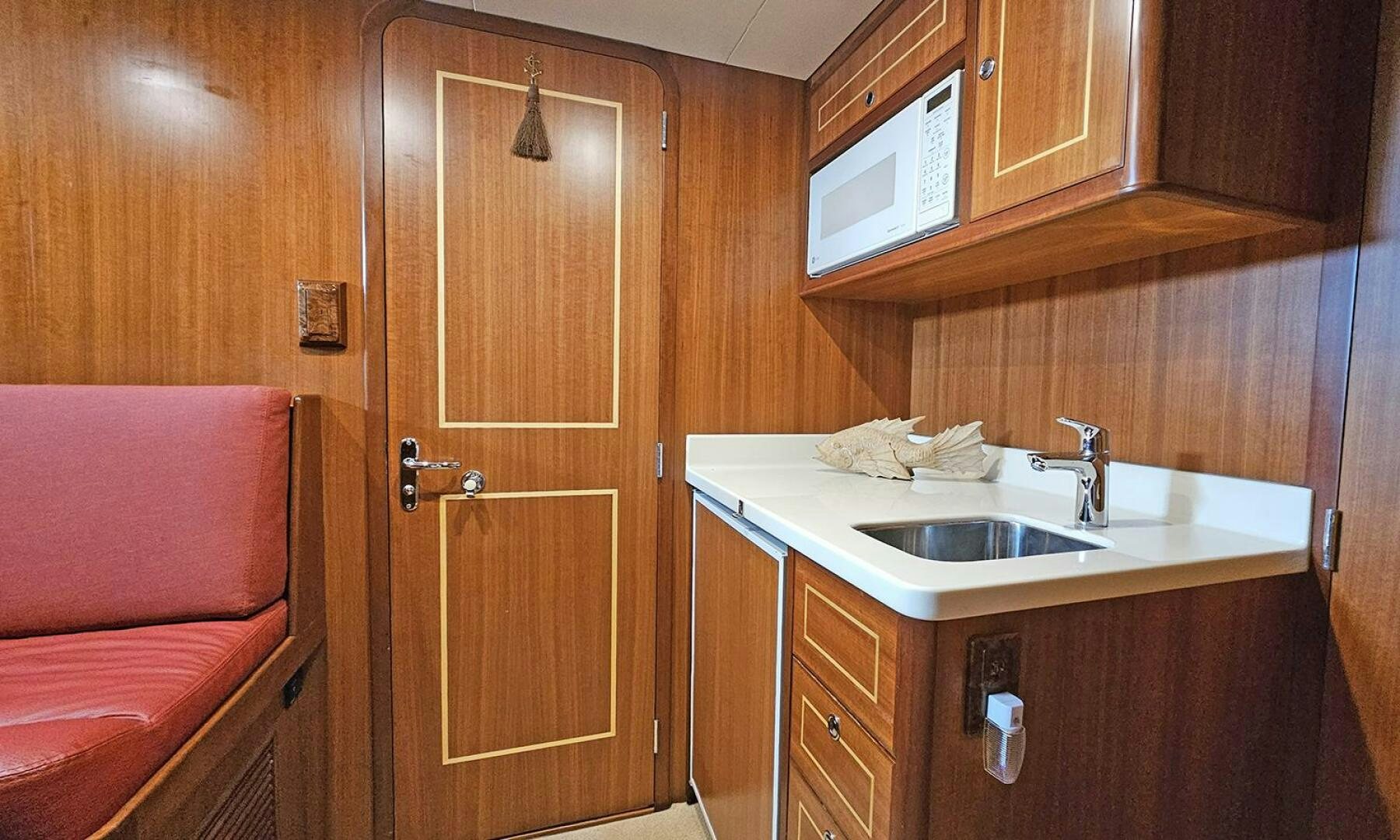 a kitchen with wooden cabinets aboard SHAMROCK Yacht for Sale