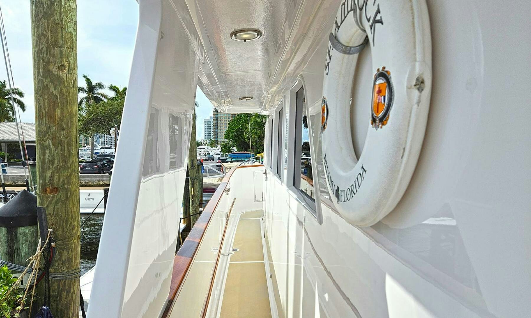 a white boat on a deck aboard SHAMROCK Yacht for Sale