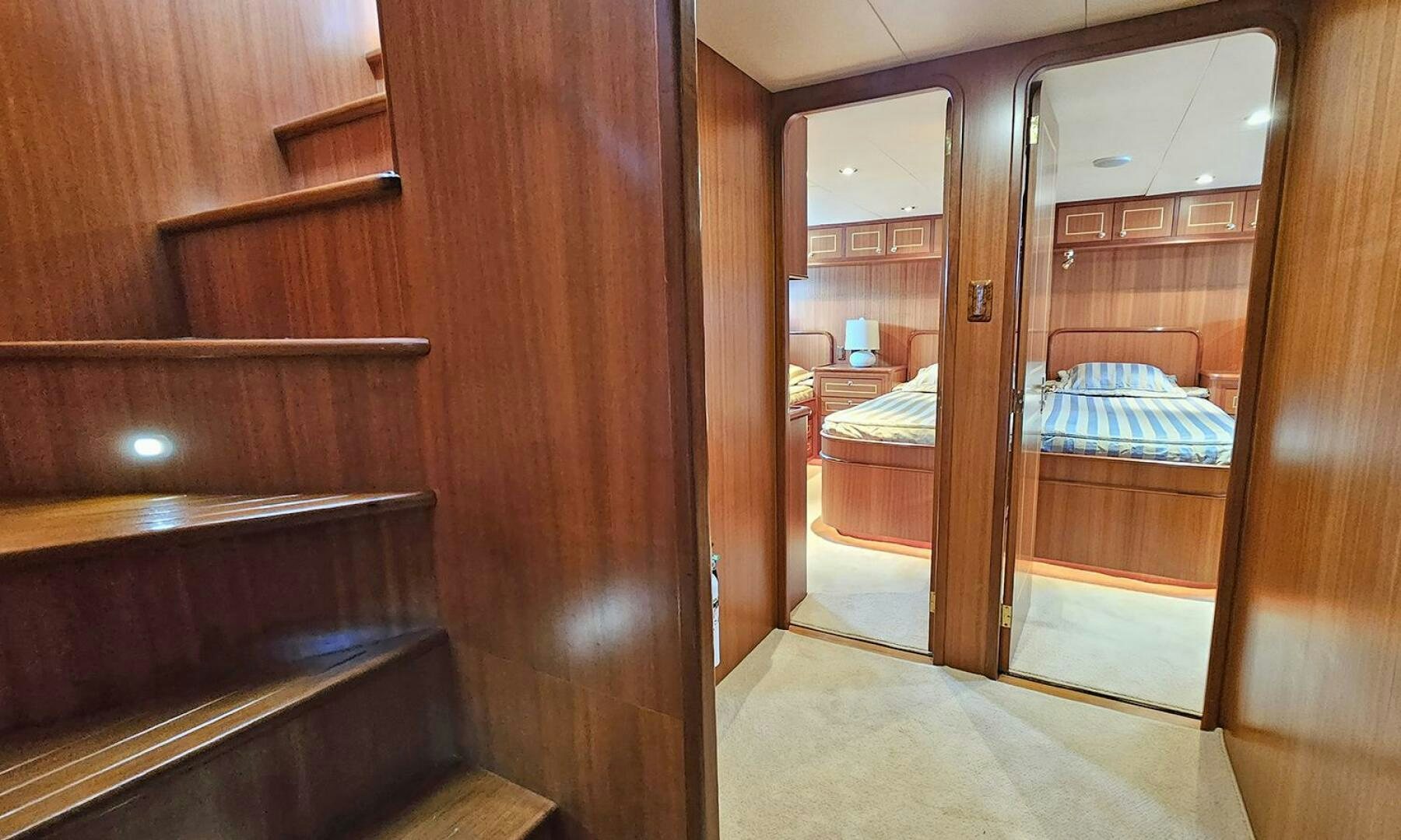 a room with a bed and a mirror aboard SHAMROCK Yacht for Sale