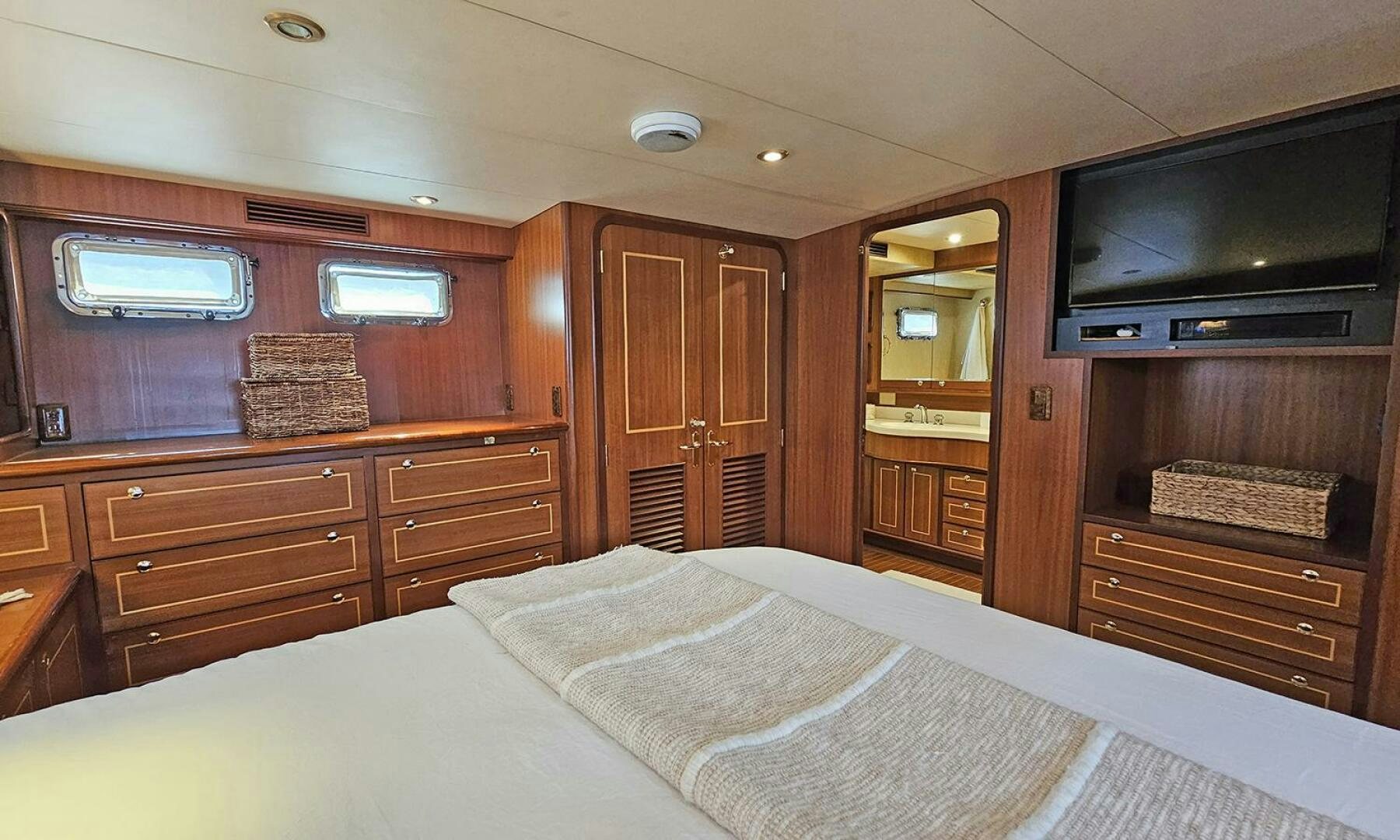 a bedroom with a bed and a television aboard SHAMROCK Yacht for Sale