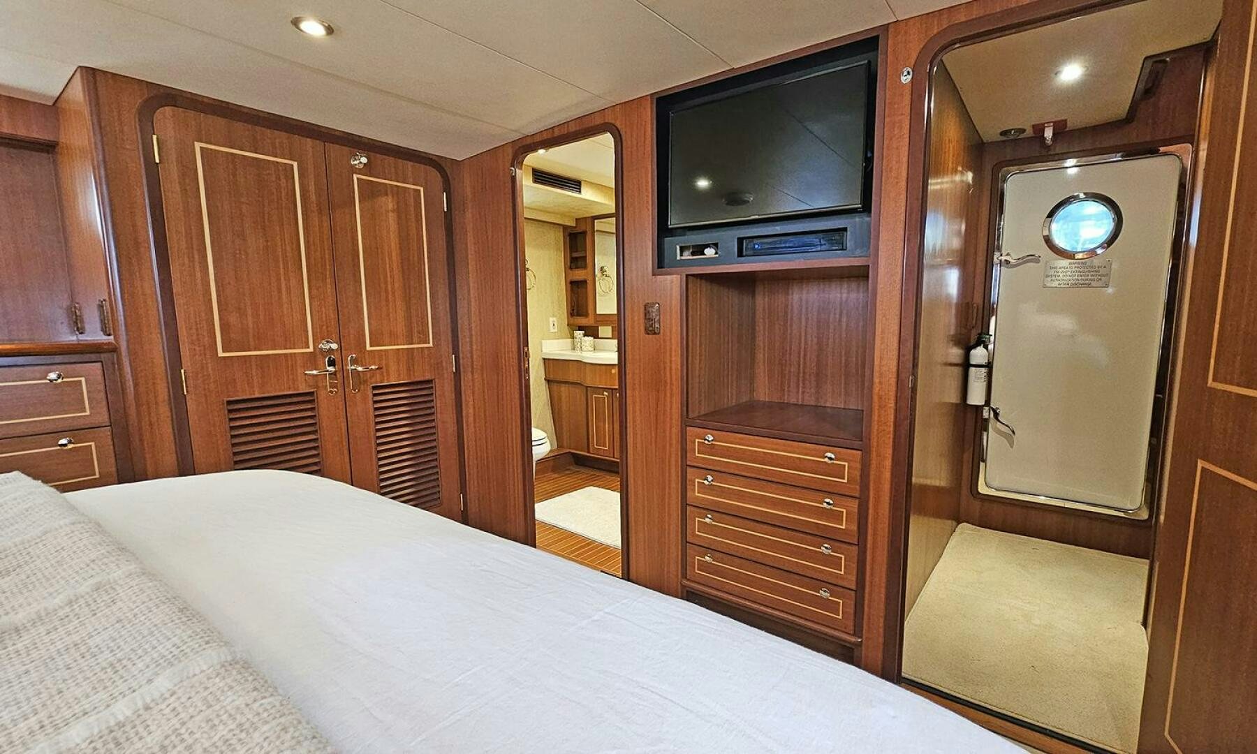 a bedroom with a bed and a television aboard SHAMROCK Yacht for Sale