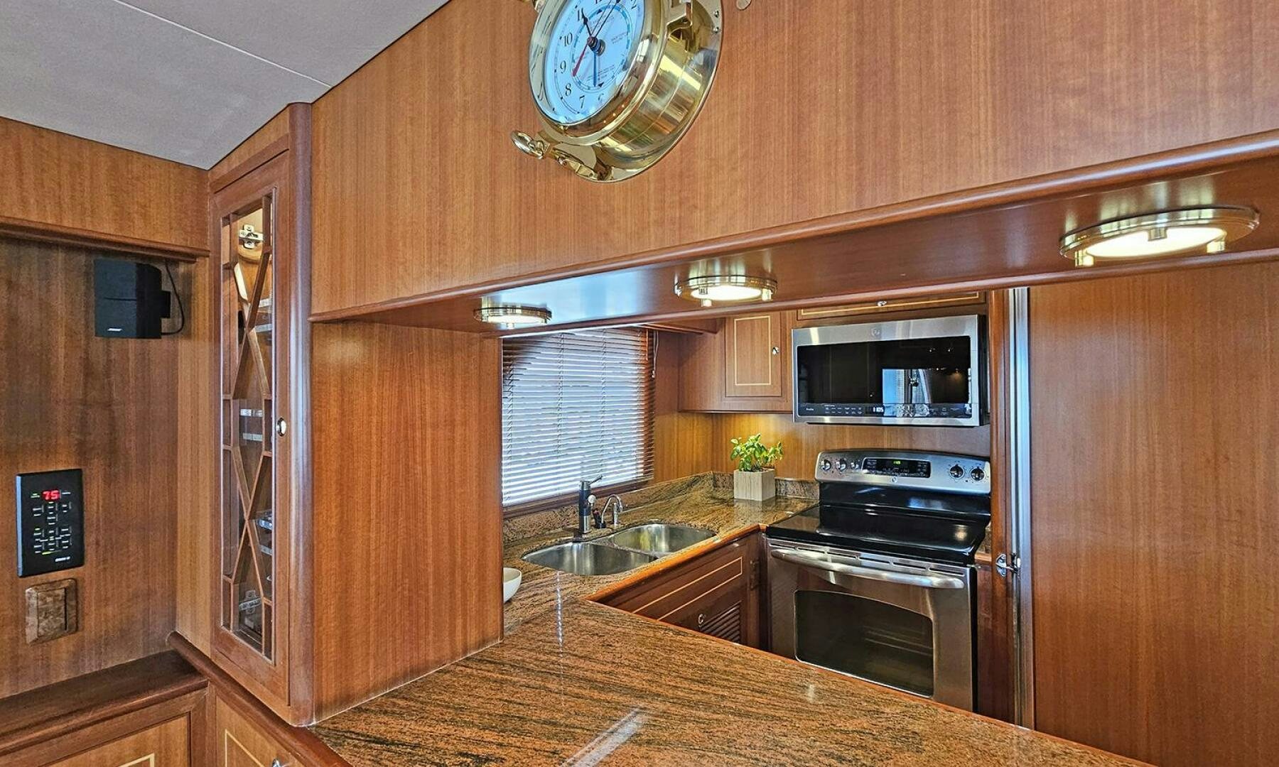 a kitchen with wooden cabinets aboard SHAMROCK Yacht for Sale