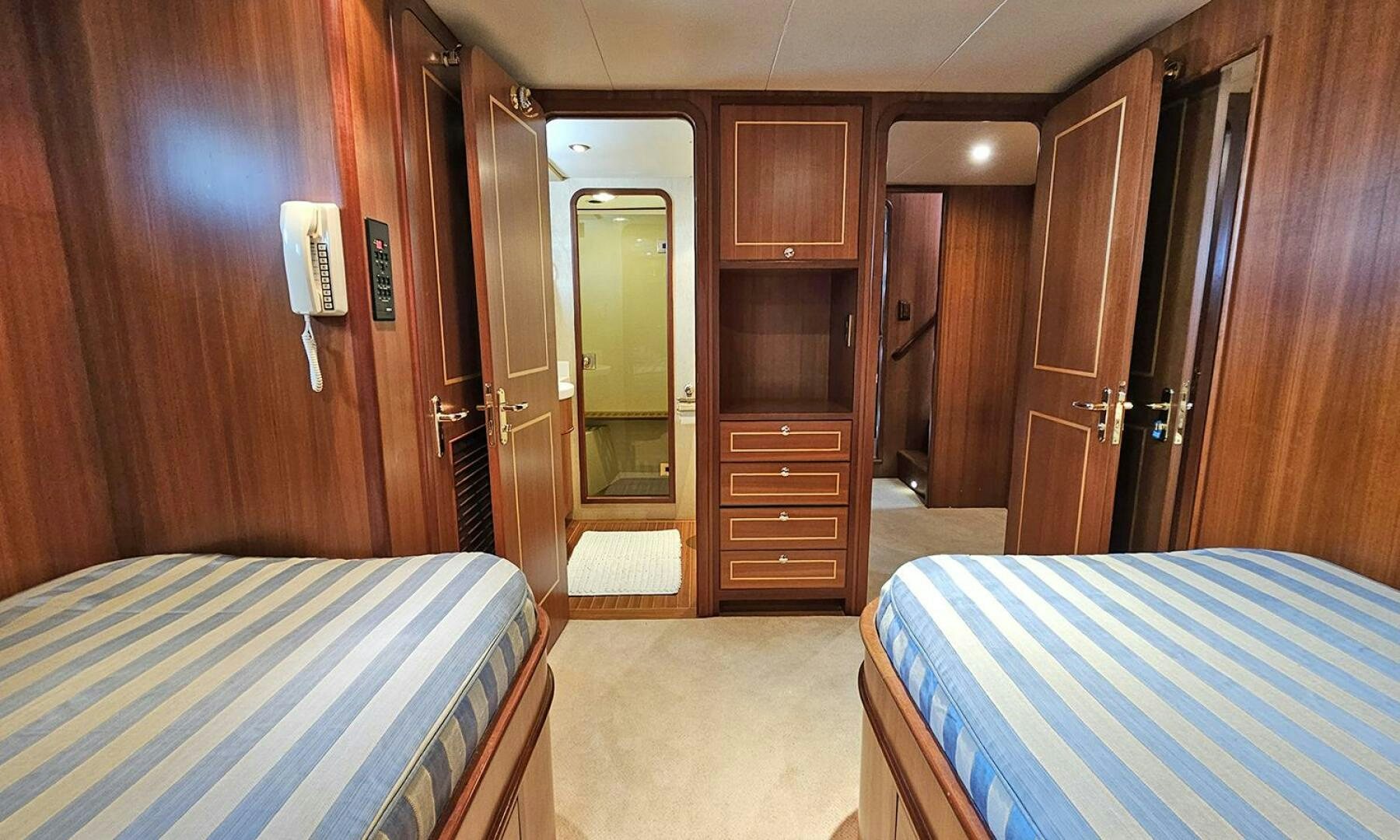 a room with a bed and a telephone aboard SHAMROCK Yacht for Sale
