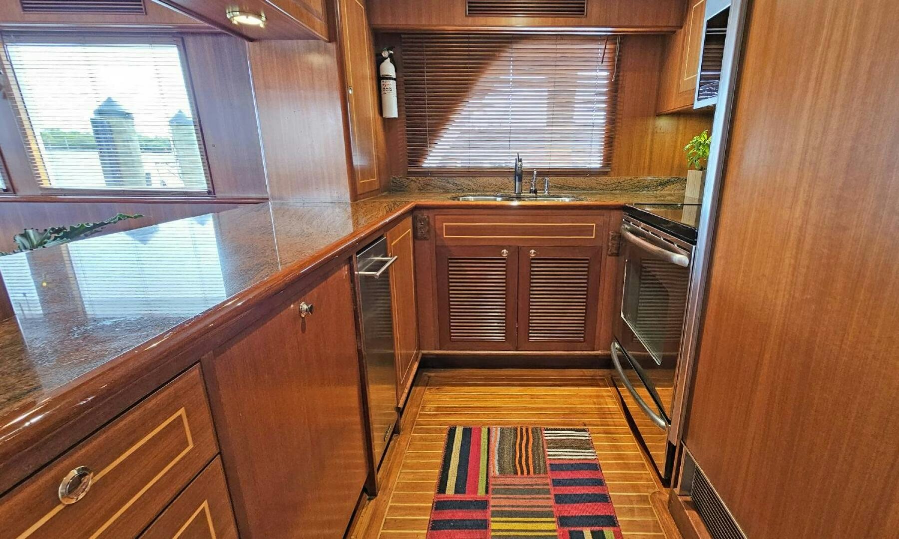 a kitchen with wooden cabinets aboard SHAMROCK Yacht for Sale