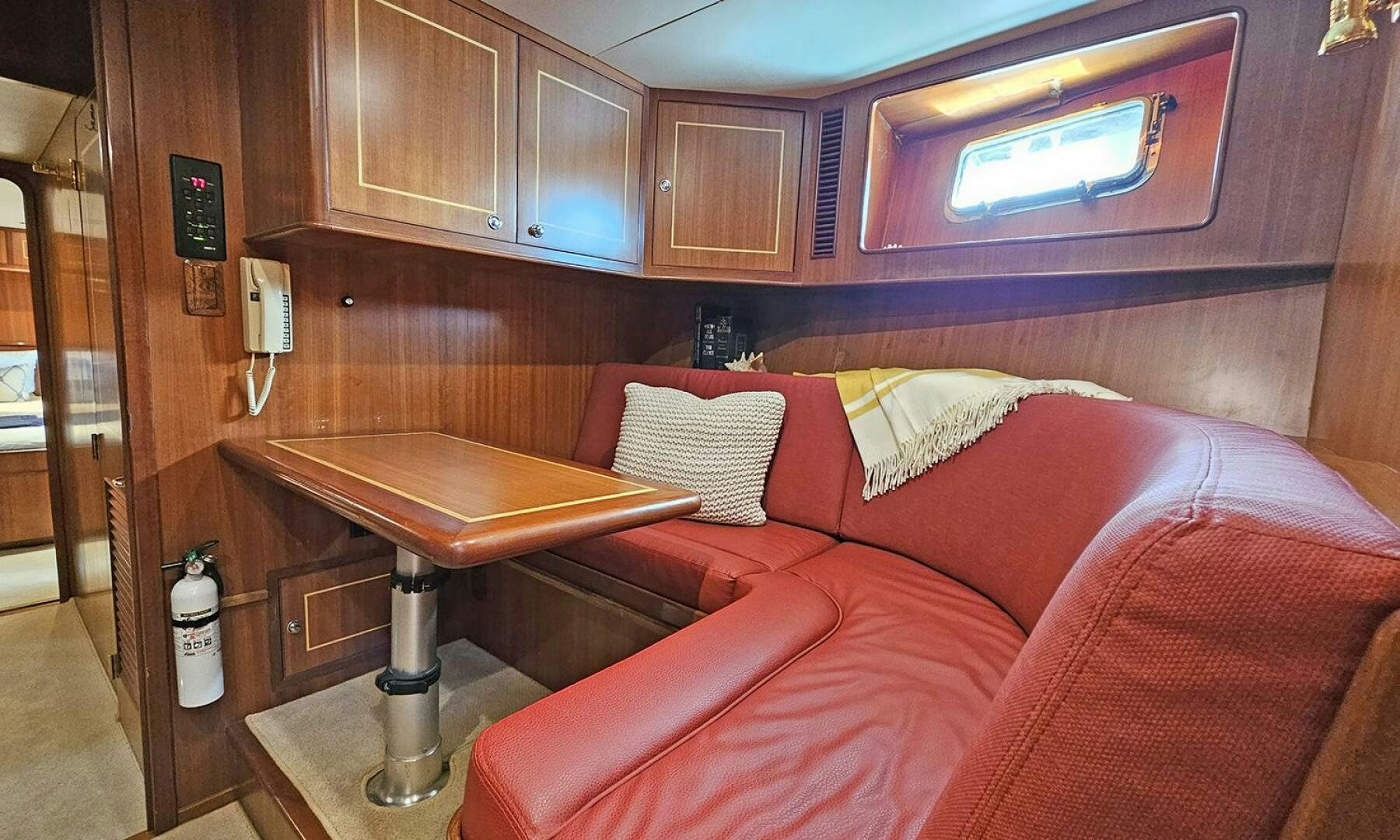 a bed with a red couch aboard SHAMROCK Yacht for Sale