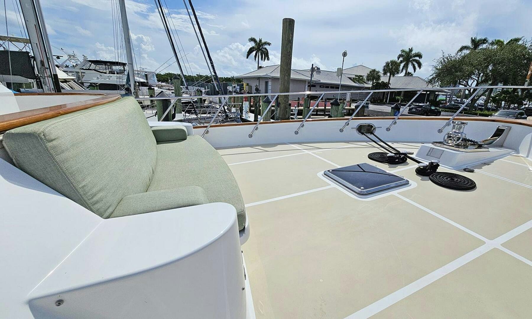 a white lounge chair next to a laptop on a table aboard SHAMROCK Yacht for Sale